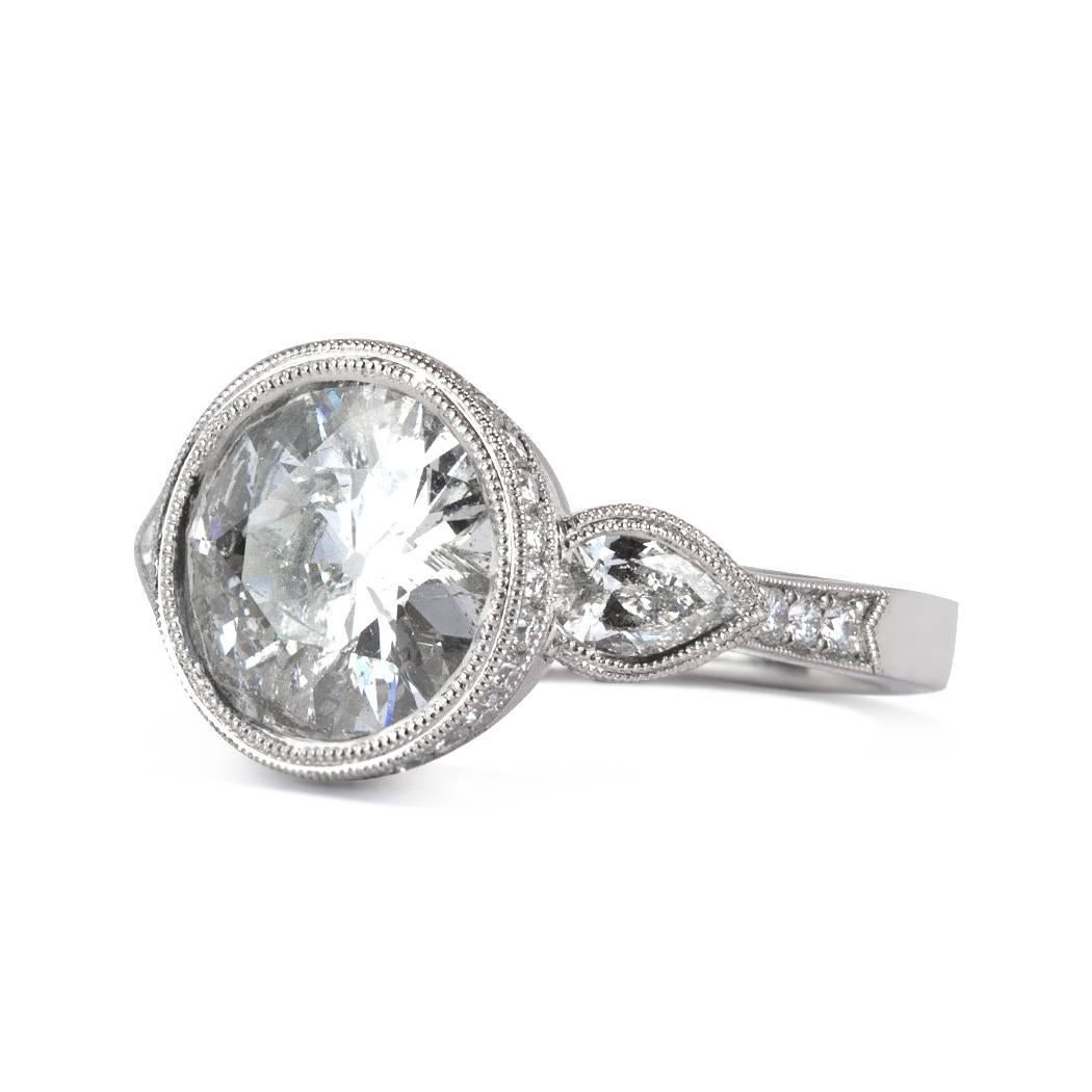 This unique diamond engagement ring showcases a gorgeous 3.02ct old European cut center diamond, EGL certified at H-SI2. It is accented by two pear shaped diamonds bezel set on either sides and for added sparkle, the top portion of the platinum