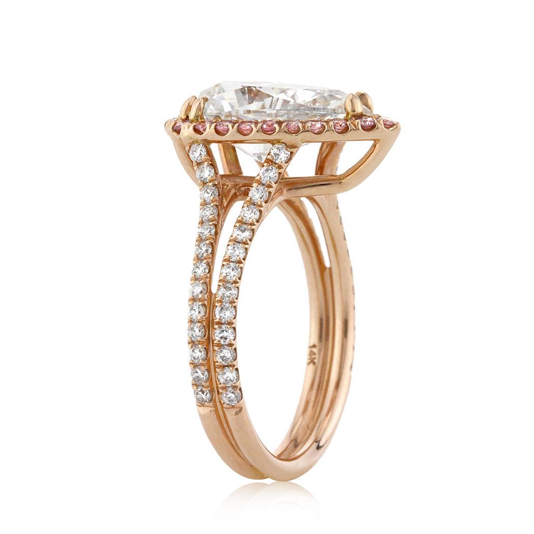 This captivating diamond engagement ring features a gorgeous 3.01ct pear shaped center diamond, GIA certified at I-VS1. It is beautifully showcased in a custom, 18k rose gold setting and accented by a halo of fancy vivid pink diamonds as well as
