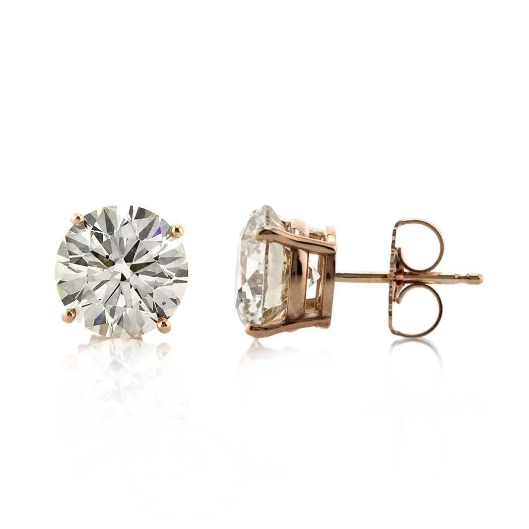 This gorgeous pair of diamond stud earrings showcases two round brilliant cut diamonds with a total weight of 4.45ct and each GIA certified at M-VS1 and S-T, SI1. They are set on a four-prong, 14k rose gold setting with butterfly backs.
