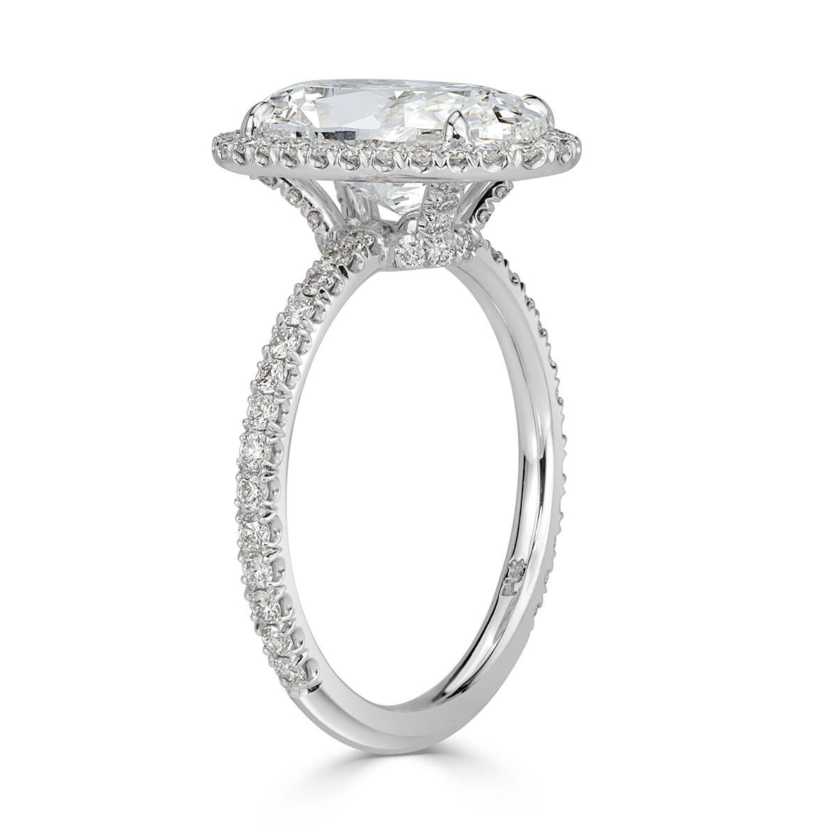 Created in high polish platinum, this sublime diamond engagement ring showcases a unique 4.01ct oval cut center diamond, GIA certified at G-SI1. It faces up absolutely white and is perfectly eye clean! It is accented by a dainty micro pavé halo as