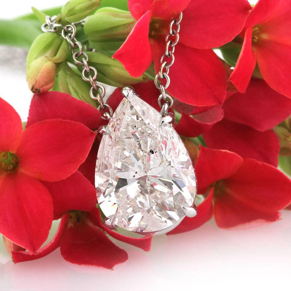 This superb diamond pendant features an exceptional 4.73ct pear shaped diamond, GIA certified at G in color SI2 in clarity. It is handcrafted to perfection in a solitaire setting style and hangs beautifully from an 18k white gold chain with loops at