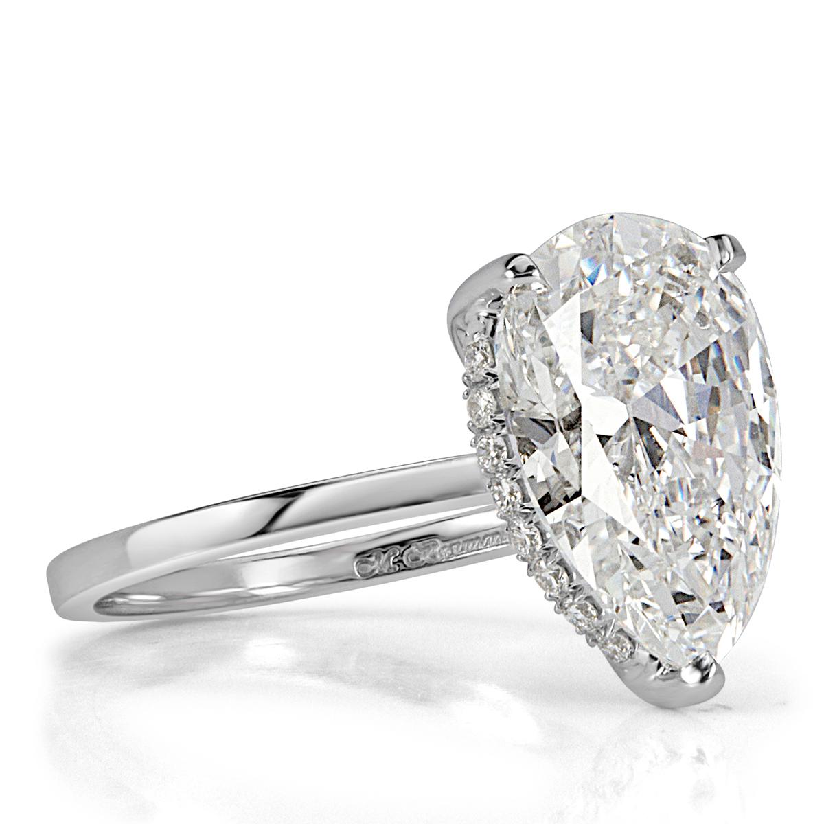 Absolutely breathtaking from every angle, this stunning diamond engagement ring features a mesmerizing 4.73ct pear shaped center diamond, GIA certified at G-VS1. For added sparkle, it is wrapped in an underlying halo of round brilliant cut diamonds