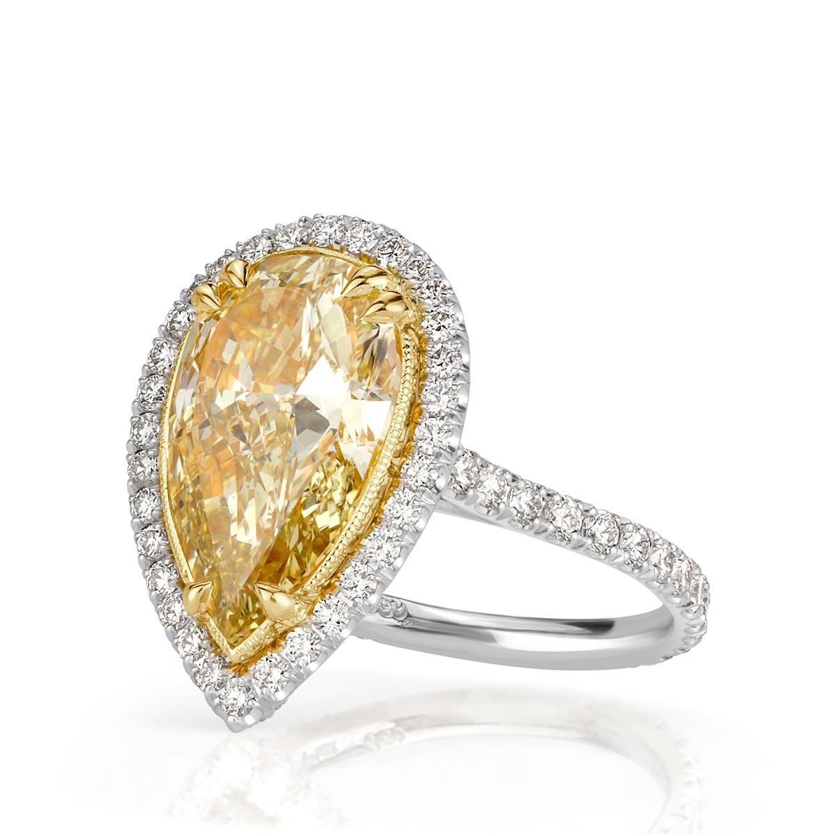 This stunning diamond engagement ring showcases a one-of-a-kind 4.06ct pear shaped center diamond, GIA certified at fancy light yellow-SI1. It radiates a vibrant canary color and is perfectly eye clean in addition of having incredible measurements