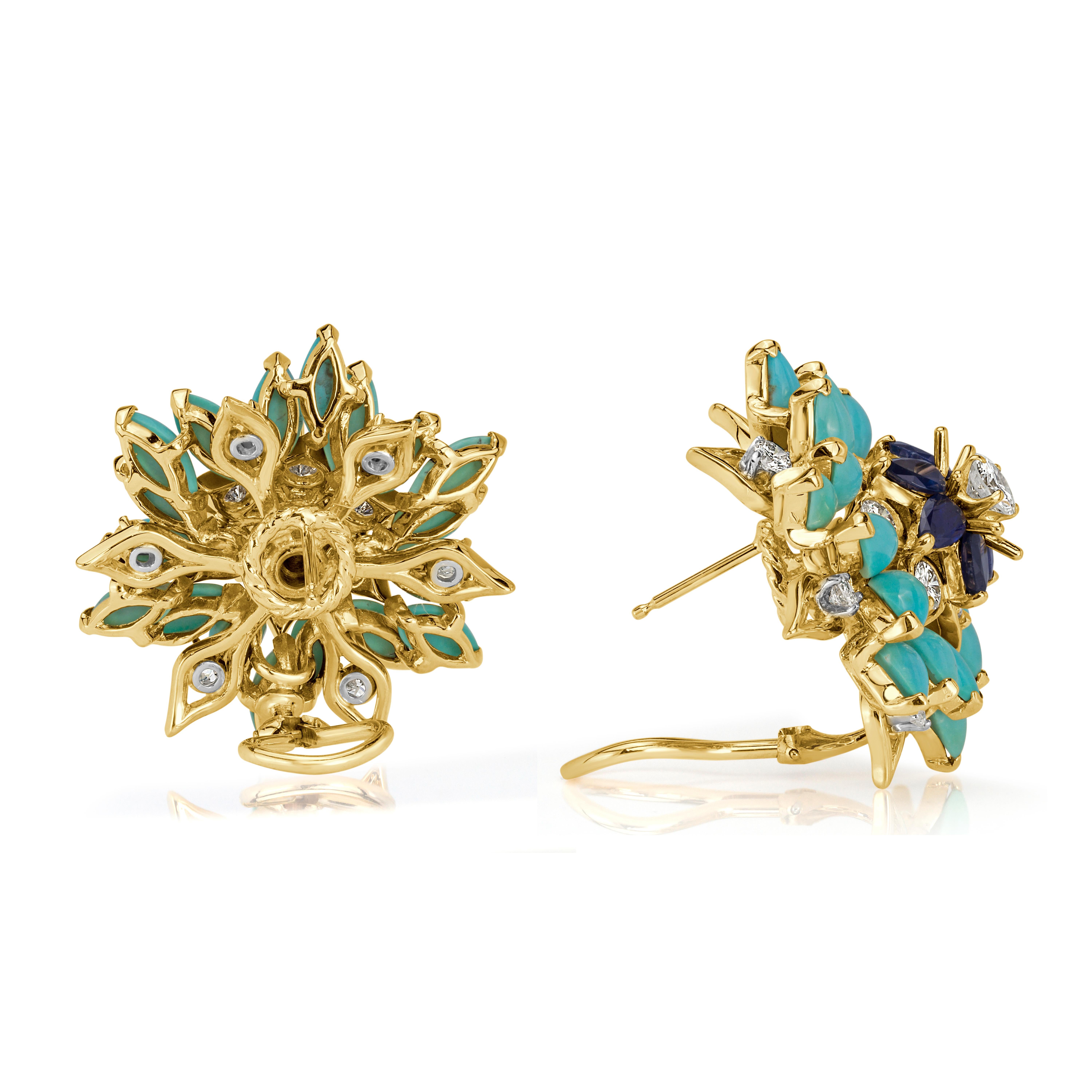 This gorgeous pair of Estate cluster earrings showcases 2.40ct of pear shaped sapphires and 2.74ct of round brilliant cut diamonds arranged in a mesmerizing floral design and complimented by exquisite turquoise beads. The diamonds are graded at F-G