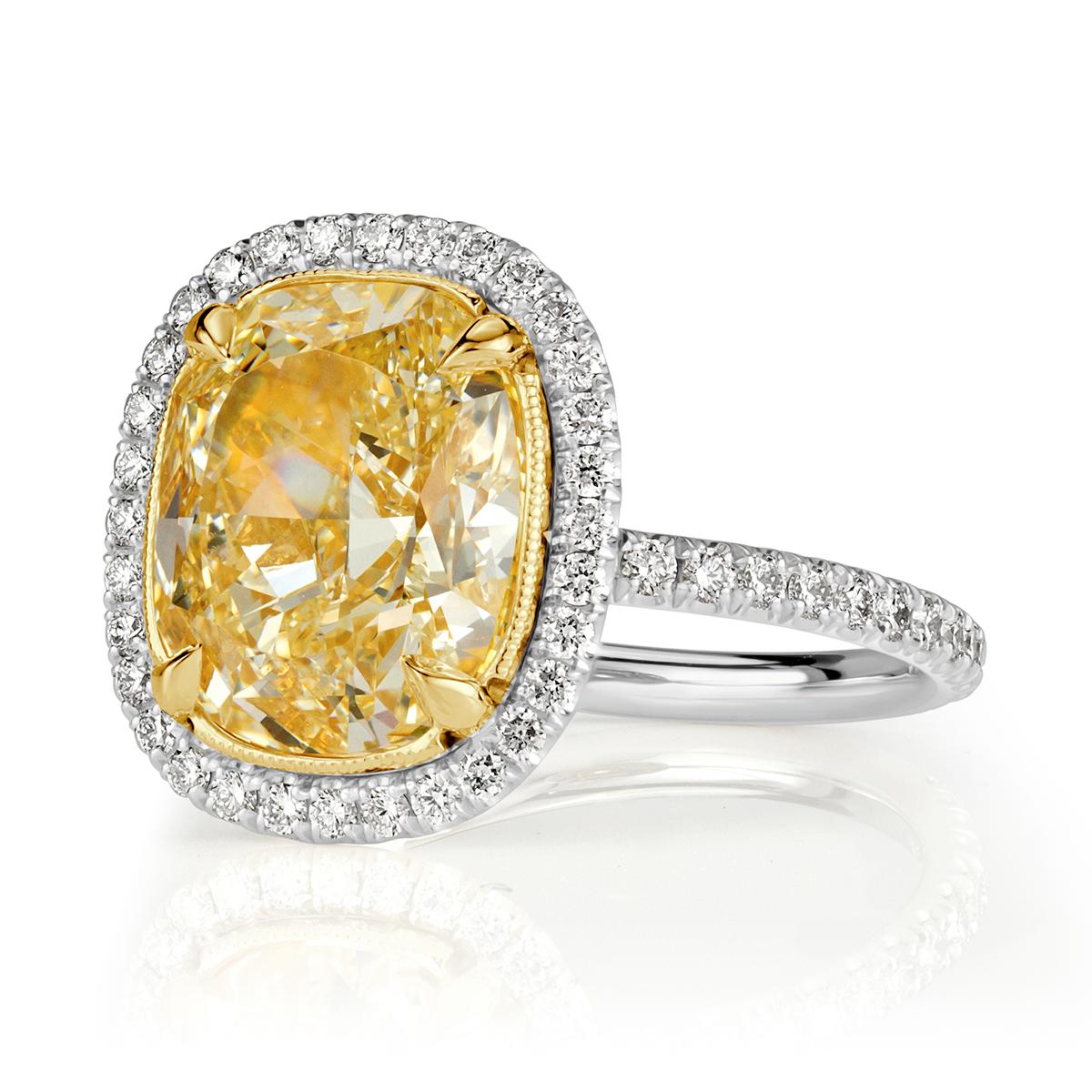 This one of a kind diamond engagement ring showcases a superb 4.52ct cushion cut center diamond, GIA certified at Z in color, VS1 in clarity. It faces up a rich yellow color and the cut is magnificent! It has incredible measurements of 10.01x8.32mm