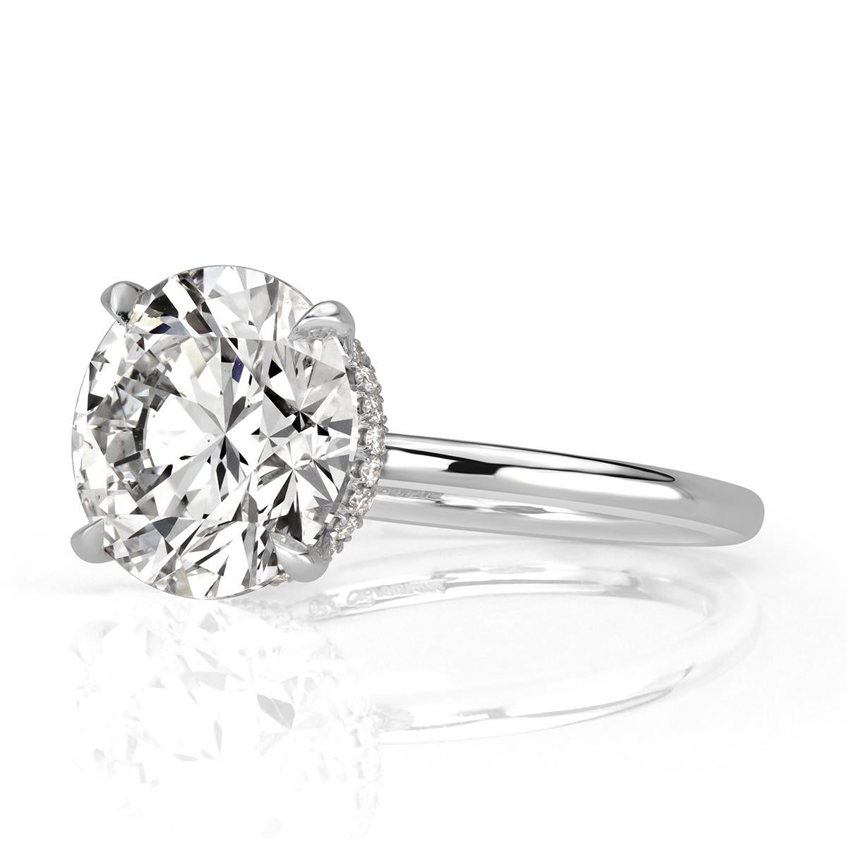 This gorgeous diamond engagement ring showcases an exceptional 5.05ct round brilliant cut center diamond,  GIA certified at H in color, SI1 in clarity. It faces up peerless white and completely eye clean in addition of being graded at excellent in