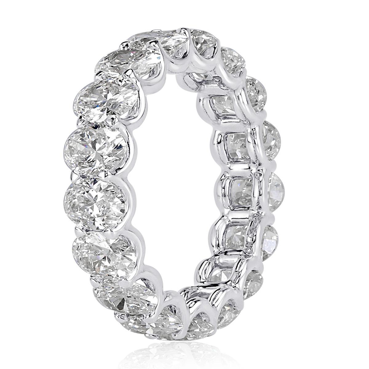 Handcrafted in high polish platinum, this diamond eternity band showcases 5.42ct of oval cut diamonds graded at E-F in color, VS1-VS2 in clarity. The diamonds are set in a 