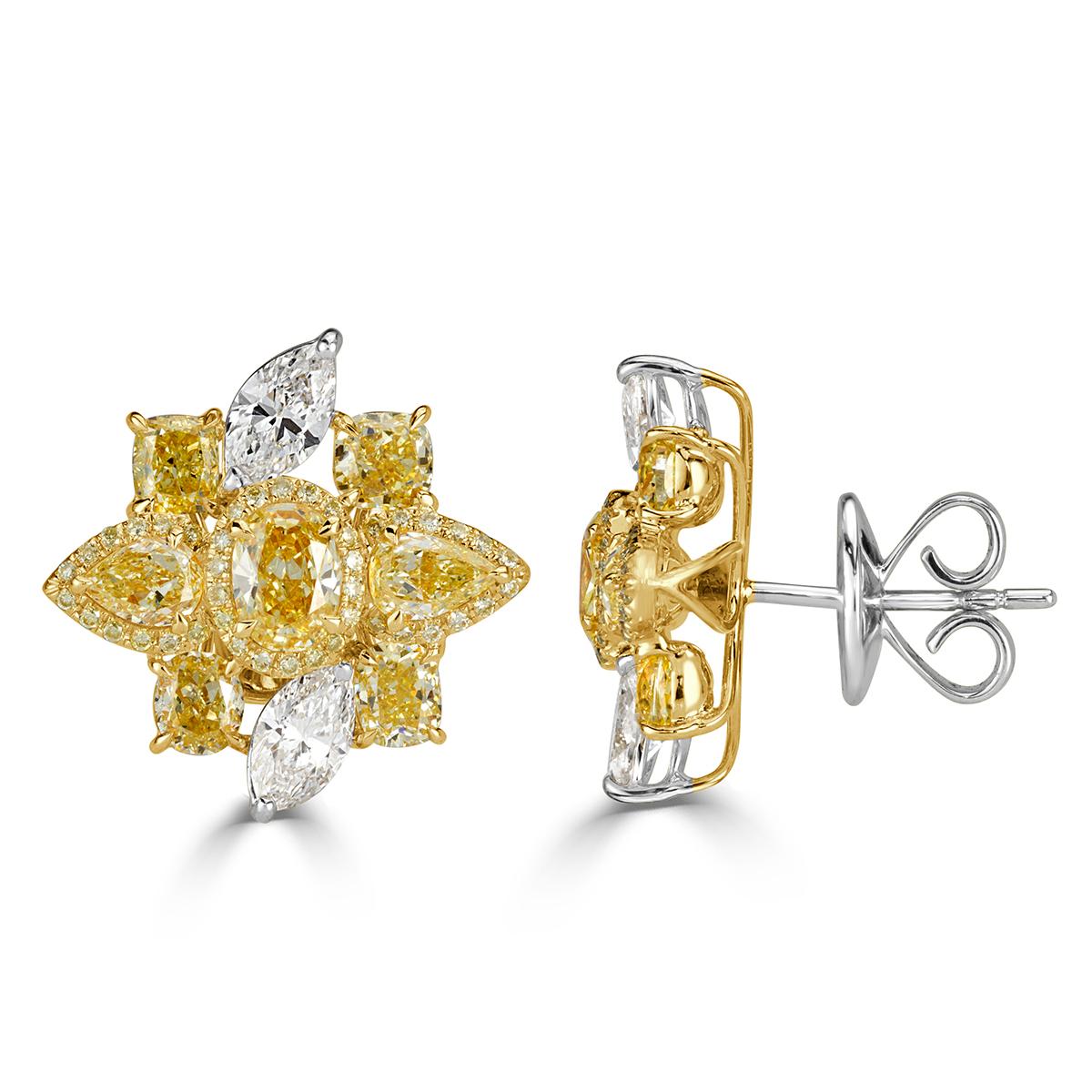 This gorgeous pair of diamond cluster earrings showcases a ravishing floral design of peerless white and fancy yellow diamonds of different shapes including pear, oval, marquise, cushion and round brilliant cut diamonds. The diamonds total 5.42ct in