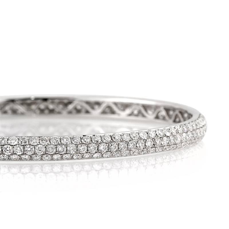 This jaw-dropping diamond pave bangle features 6.00ct of sparkling round brilliant cut diamonds. The diamonds are graded at E-F, VS2-SI2 and hand set in a high polish 14k white gold setting. The shimmery design of the three-row pave diamonds truly