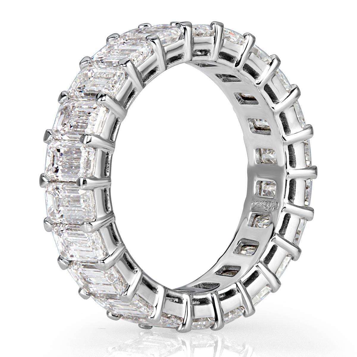 Handcrafted in high polish platinum, this superb diamond eternity band showcases 6.69ct of intensely bright emerald cut diamonds graded at E-F, VVS2-VS1. All eternity bands are shown in a size 6.5. We custom craft each eternity band and will create