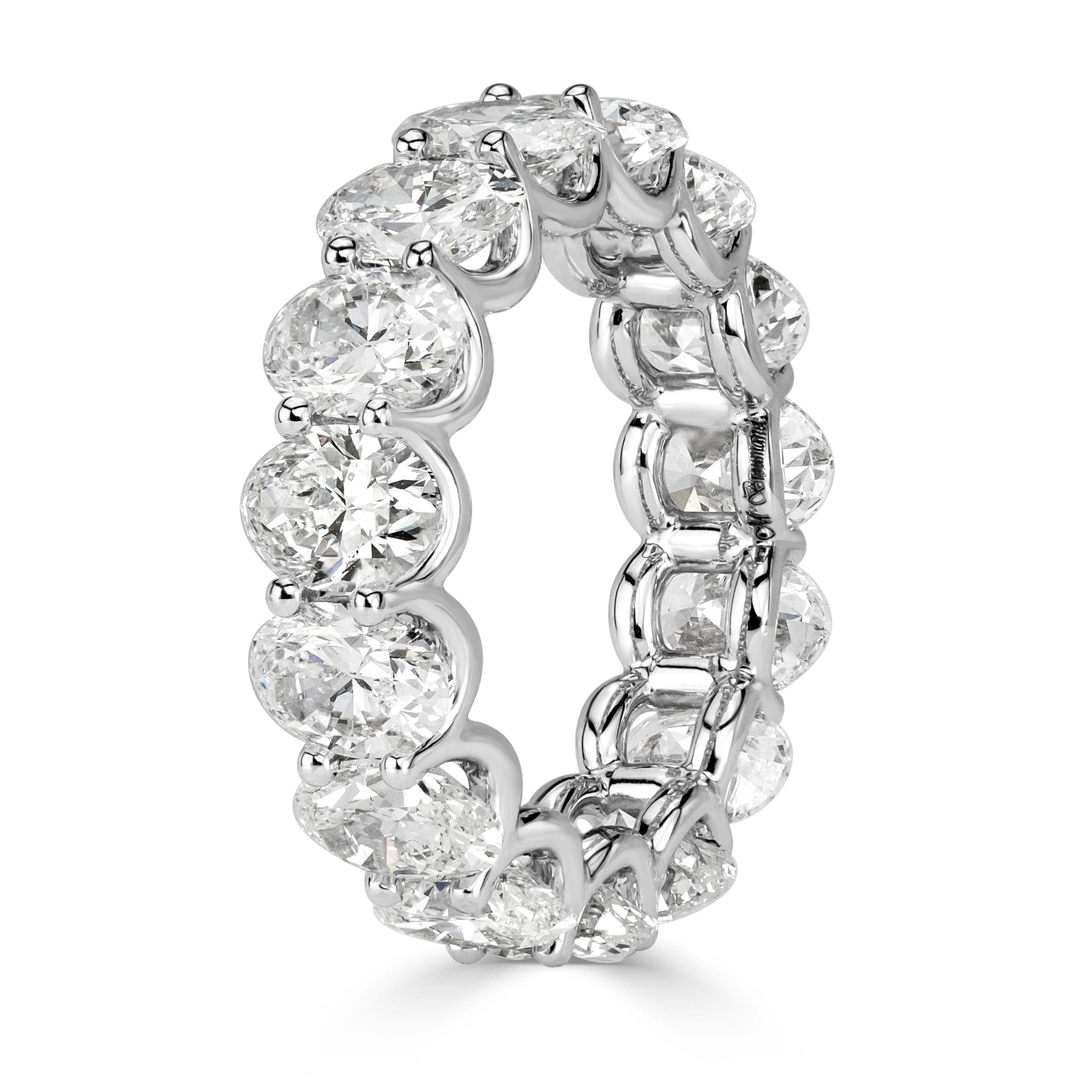 Custom created in 18k white gold, this dazzling diamond eternity band showcases 7.64ct of oval cut diamonds graded at E-F, VS1-VS2. They are seamlessly matched and set in a U-prong setting style with hardly any metal showing. All eternity bands are