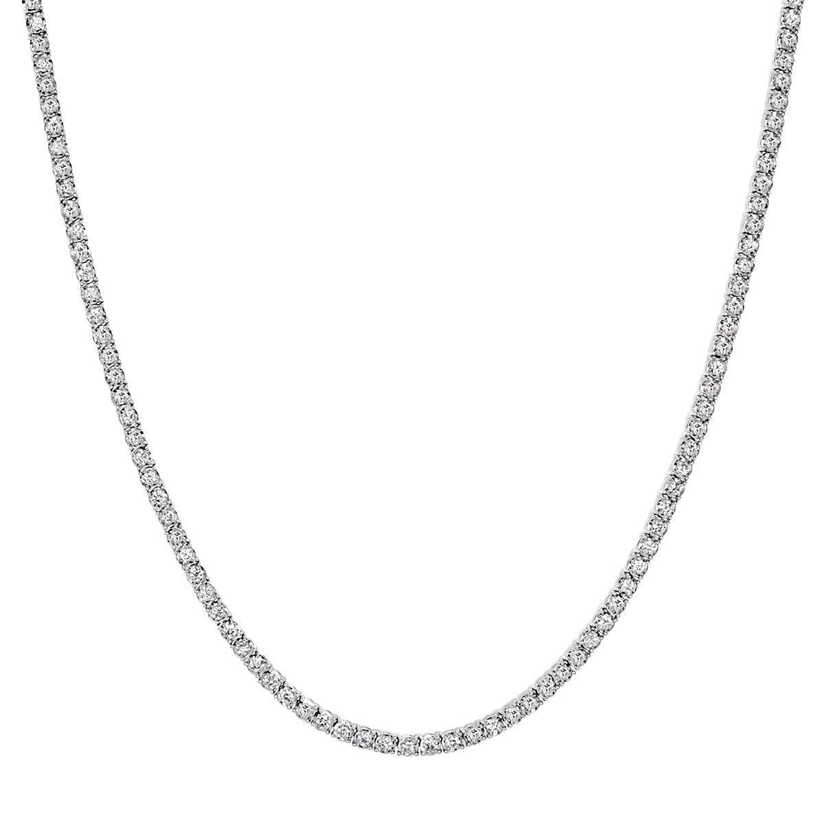 Custom created in 14k white gold, this stunning diamond tennis necklace showcases 8.00ct of round brilliant cut diamonds graded at E-F in color, VS2-SI1 in clarity. They are set in a classic for-prong setting style that appears to float on the