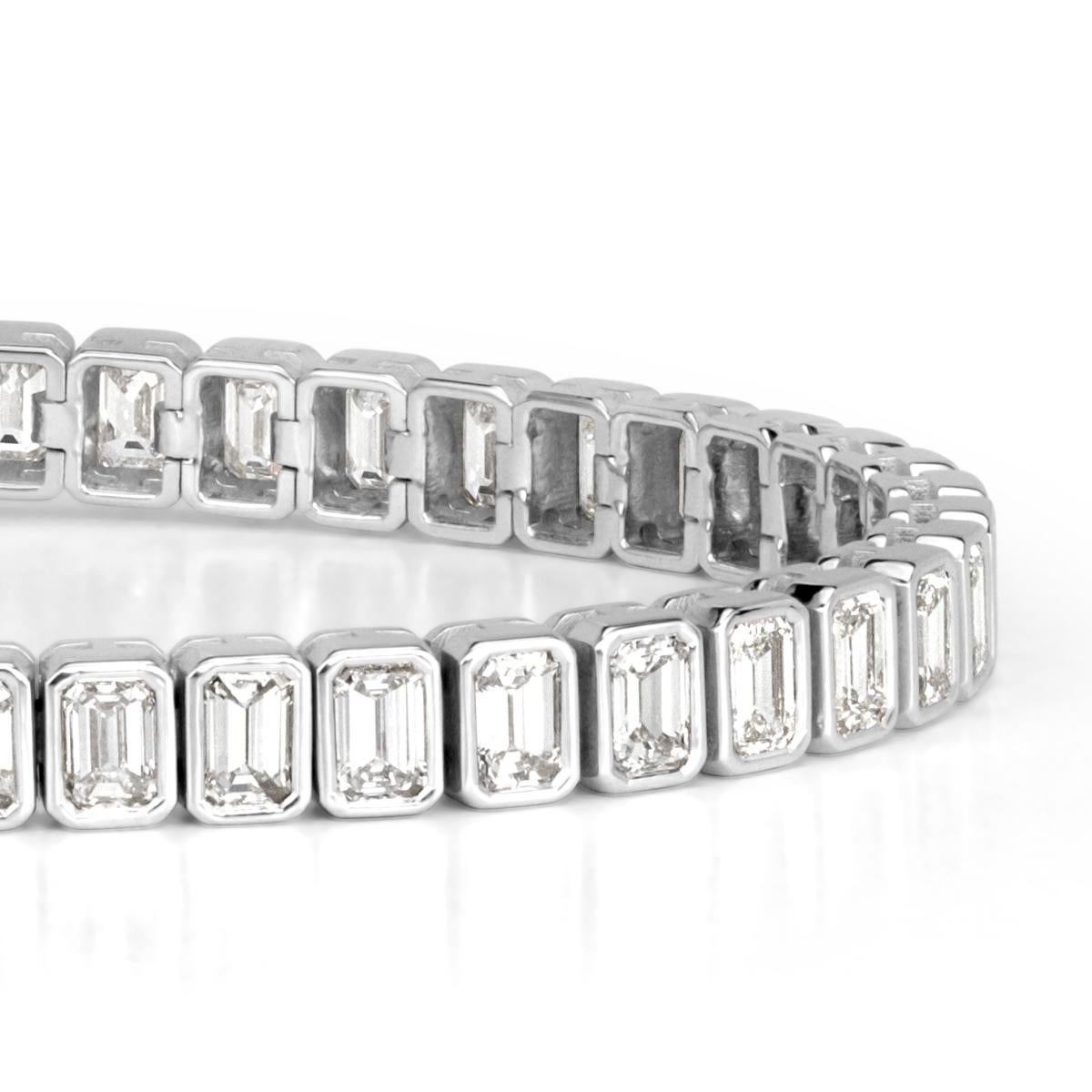 Created in a sleek 18k white gold setting, this sumptuous diamond tennis bracelet showcases 8,80ct of emerald cut diamonds matched and bezel set to perfection. The diamonds are graded at top qualities of G-H in color and VS1-VS2 in clarity.