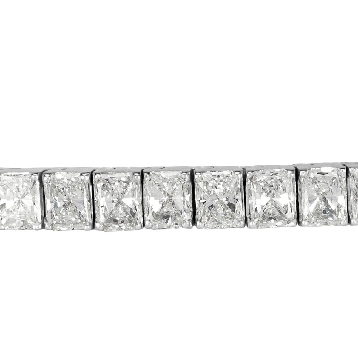 This stunning diamond tennis bracelet showcases 8.84ct of gleaming radiant cut diamonds graded at F-G in color, VS1-VS2 in clarity. They are set in a classic 18k white gold, four-prong setting style. Each of the diamonds is hand selected to match