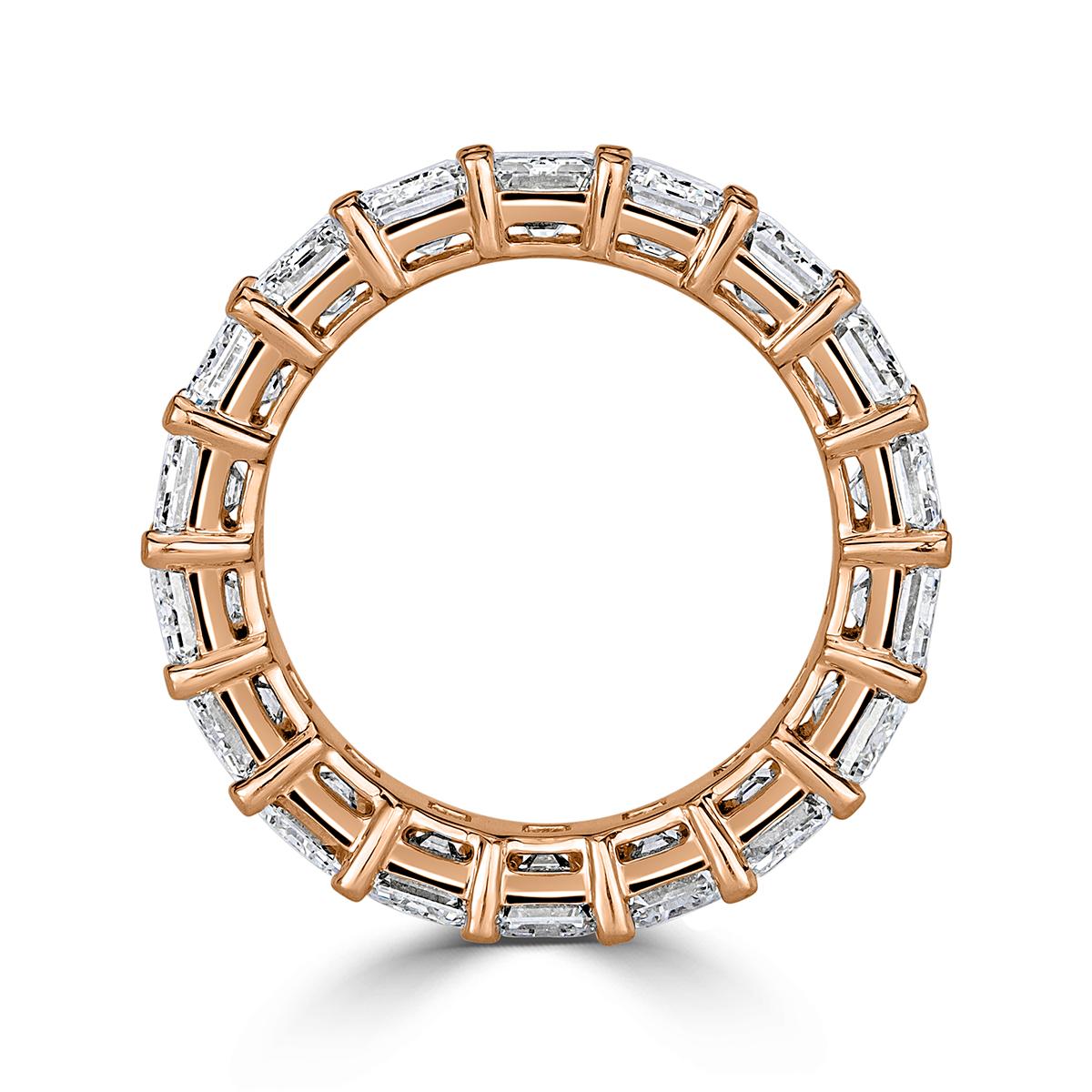 Created in 18k rose gold, this truly elegant yet timeless diamond eternity band showcases 9.09ct of perfectly matched emerald cut diamonds graded at E-F in color, VVS1-VVS2 in clarity. They are set in a classic four-prong basket setting style. All