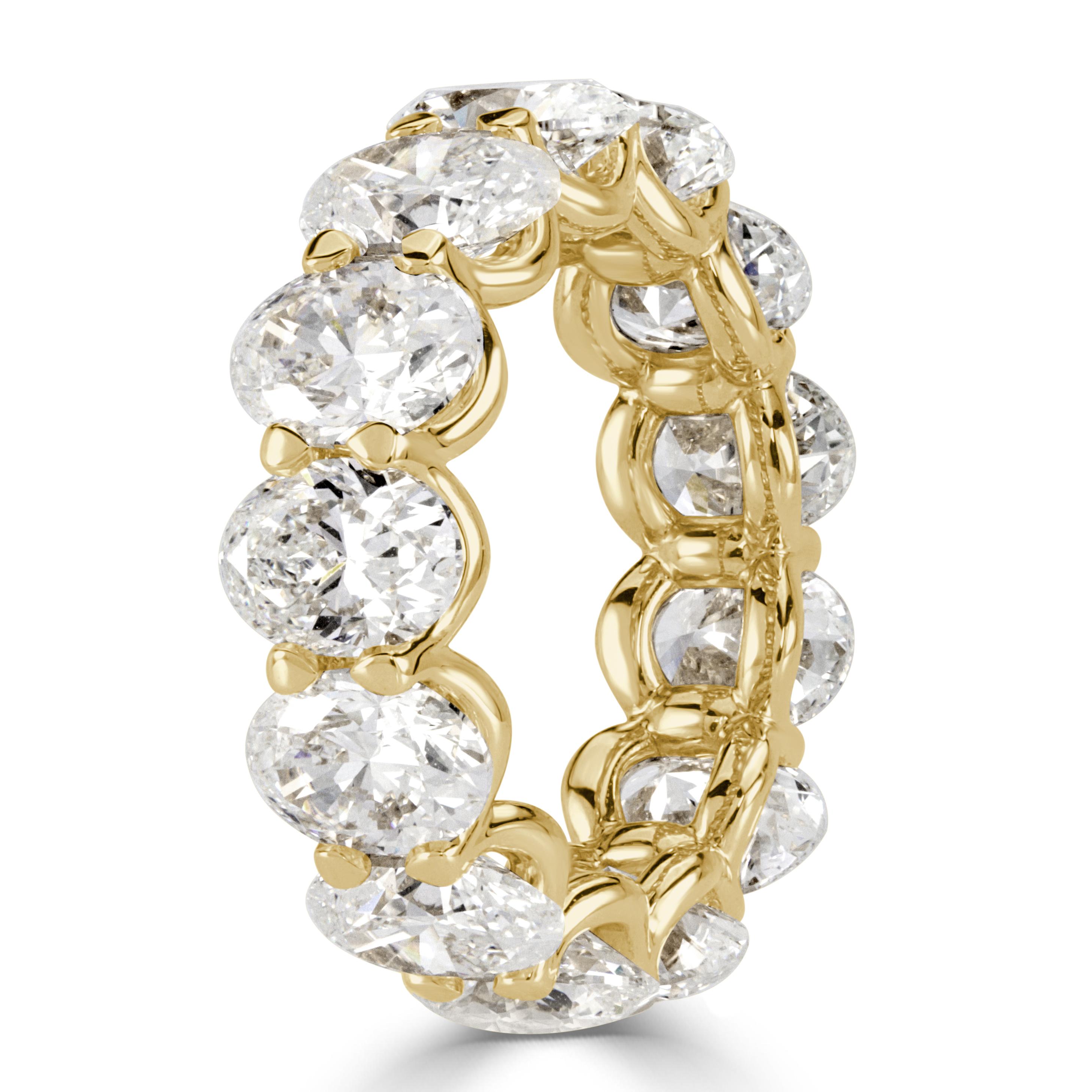 Custom created in 18k yellow gold, this mesmerizing diamond eternity band showcases 9.10ct of oval cut diamonds individually GIA certified at G-H in color, VVS1-VS2 in clarity. They weight approximately 0.70ct each and are hand selected and matched