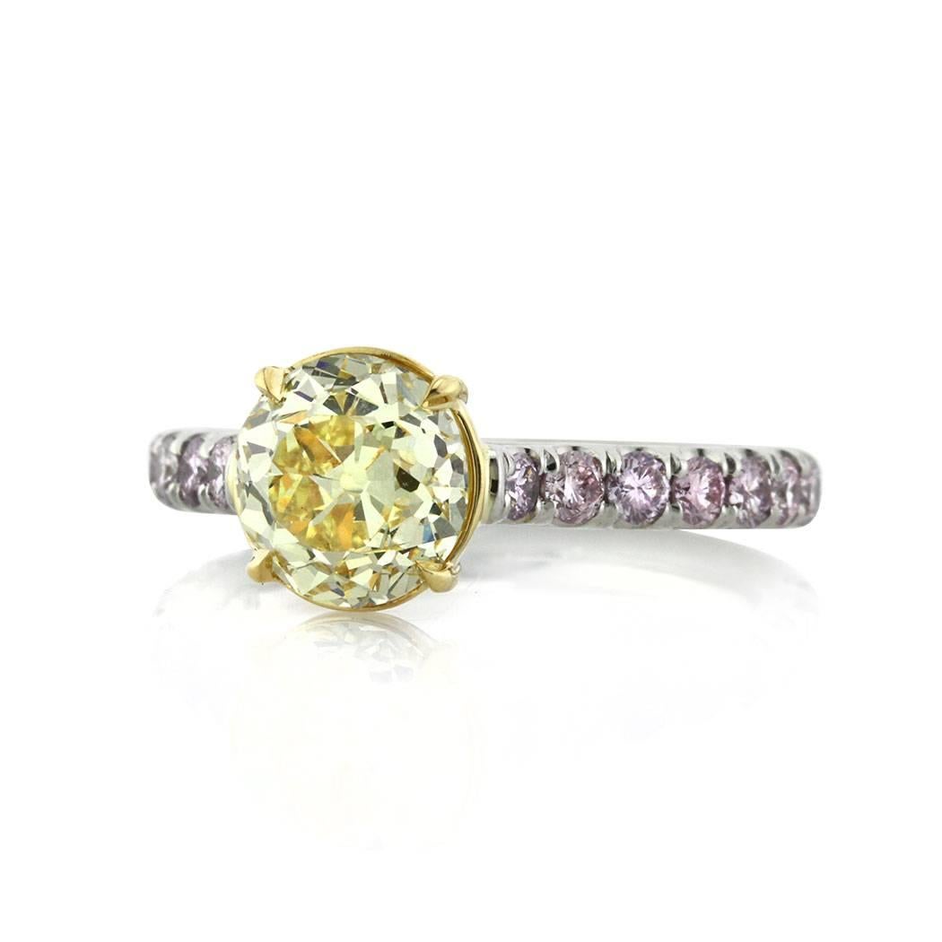 This stunning engagement ring features a gorgeous 2.10ct old European round cut center diamond GIA certified at Fancy Intense Yellow-SI1. It is accented by 0.80ct of round brilliant cut diamonds set in a pave setting on the shank. They are graded at