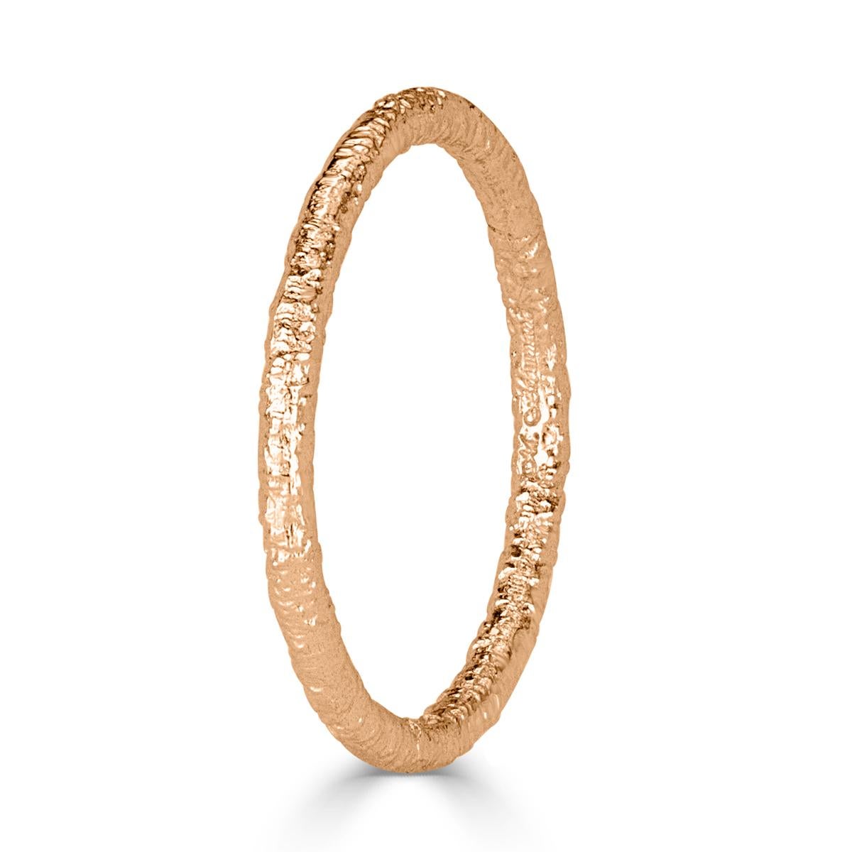Custom created in 18k rose gold, this lovely band features a textured design which looks stunning in a stack or as a stand alone piece.
