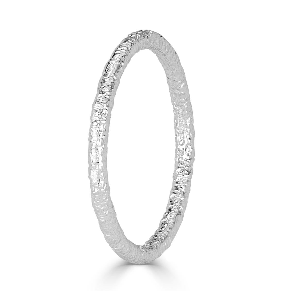 Custom created in 18k white gold, this lovely band features a textured design which looks stunning in a stack or as a stand alone piece.
