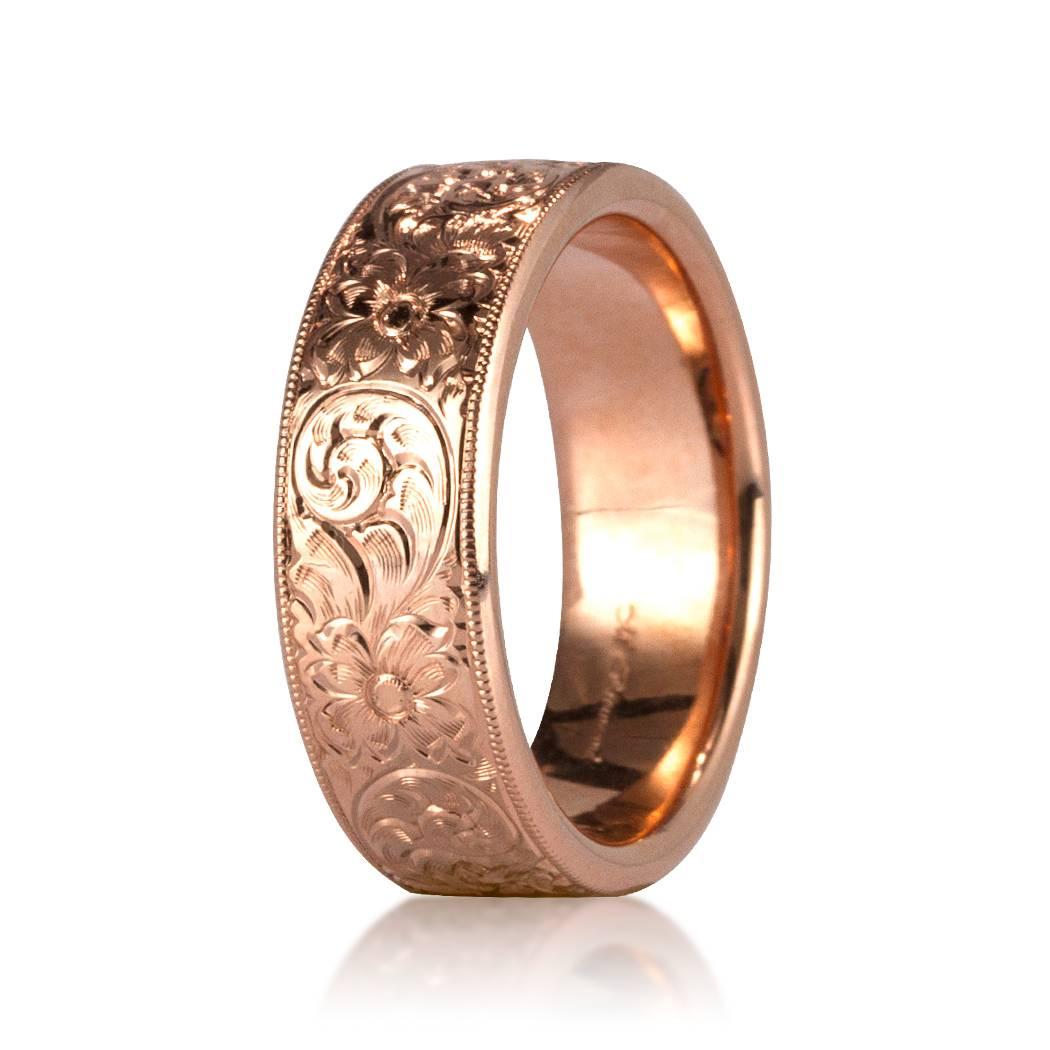 This comfort-fit 18k rose gold wedding band showcases beautiful hand engraved details throughout its entire circumference giving it a unique vintage look. We custom craft each eternity band and will create the same design for you in your desired