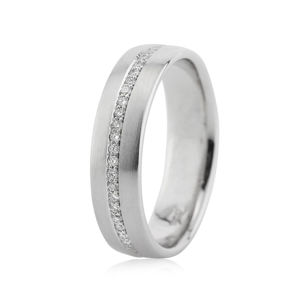 This men's diamond eternity wedding band showcases 0.50ct of round brilliant cut diamonds set in a pave setting style and running through the whole circumference of the ring. They are set in a 14k white gold setting with a satin finish. All men's