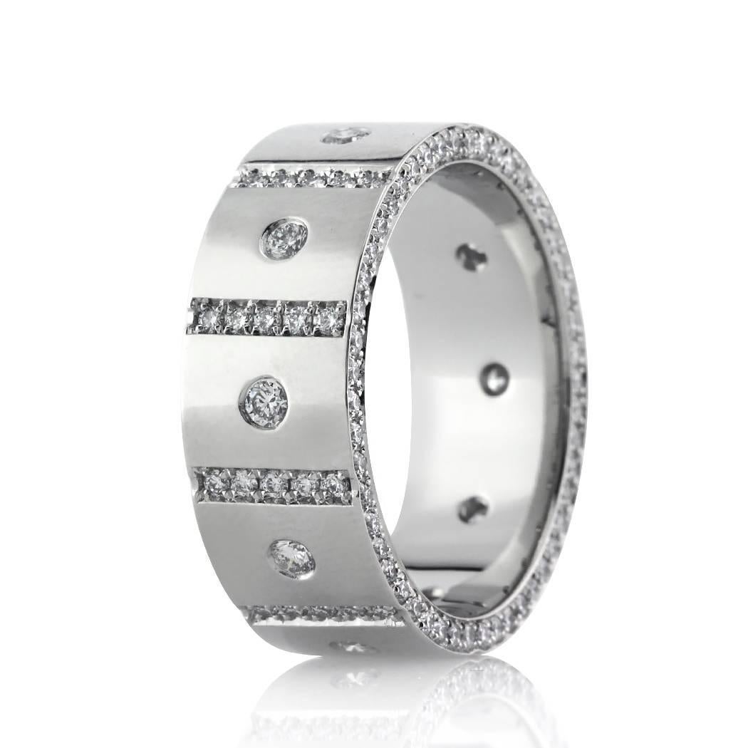 This stunning diamond men's wedding band features an 8mm width and showcases 1.90ct of larger round diamonds set in a flush setting on top accented with rows of round brilliant cut diamonds pavé set in between them. The front and back of the ring