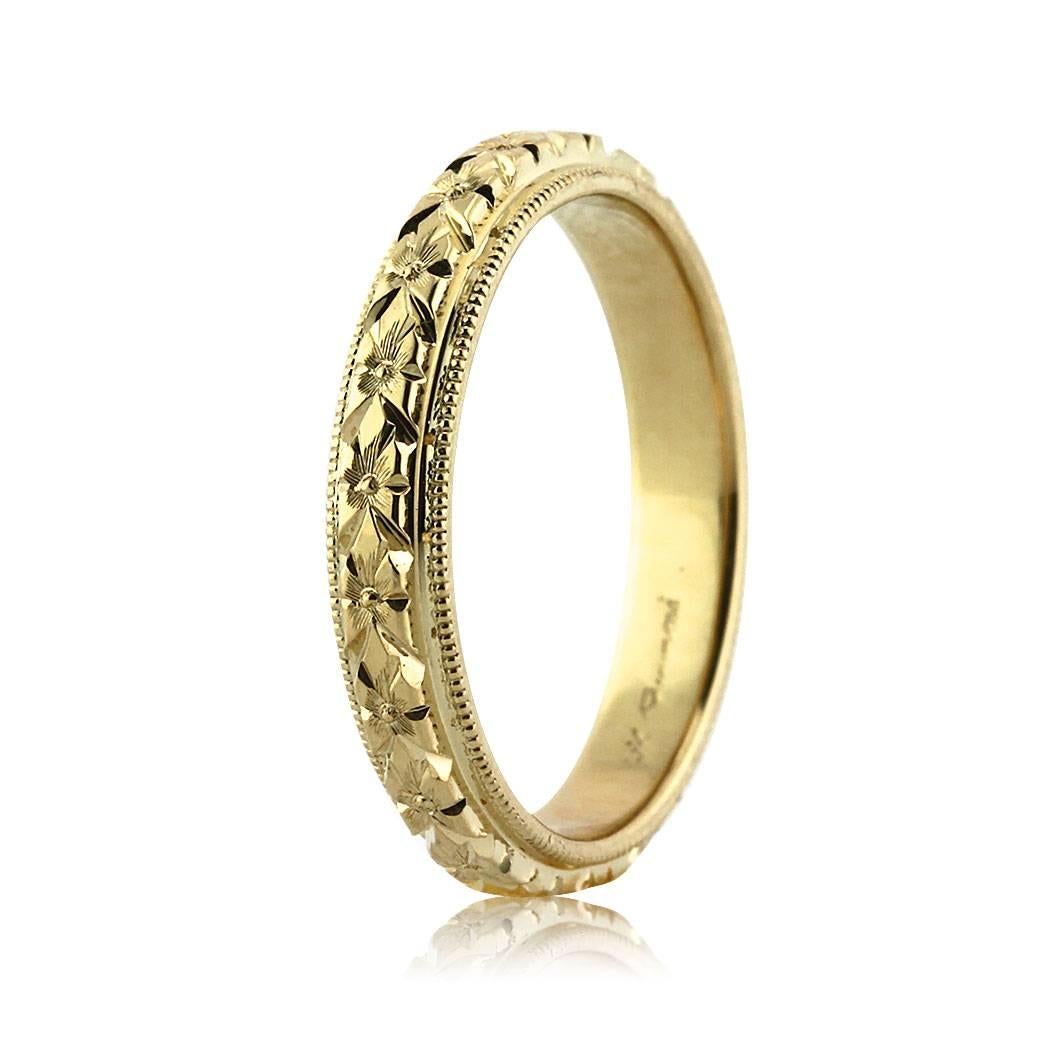 Custom created in 18k yellow gold, this ravishing wedding band is hand etched to perfection with exquisite design and accented with milgrain detail on either side. All eternity bands are shown in a size 6.5. We custom craft each eternity band and