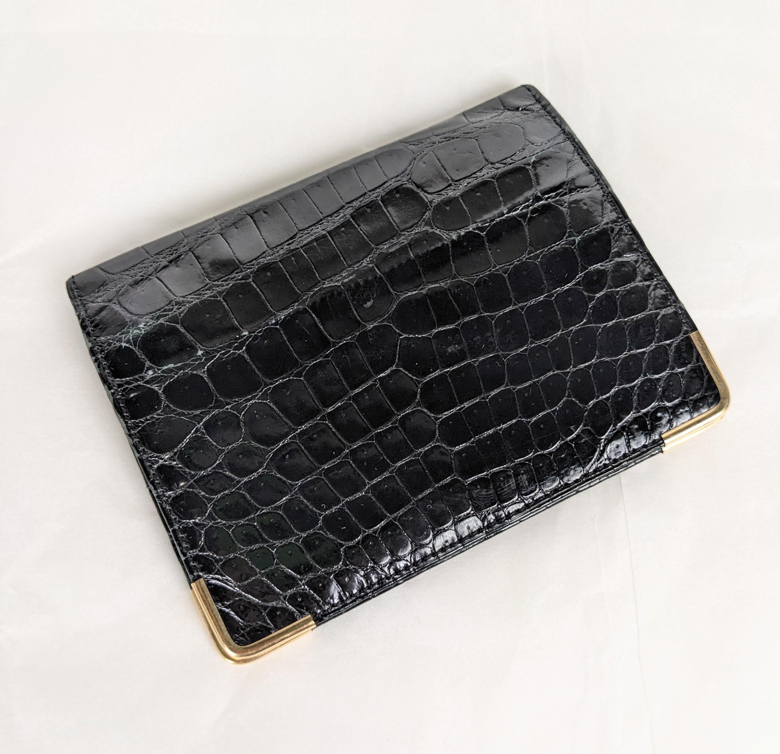 Mark Cross Alligator Fold with 14k Gold Trim from the 1950's. One exterior compartment with 3 interior slots. Each corner is crafted in 14K gold for protection. Calf leather lining. 1950's USA. 4.25