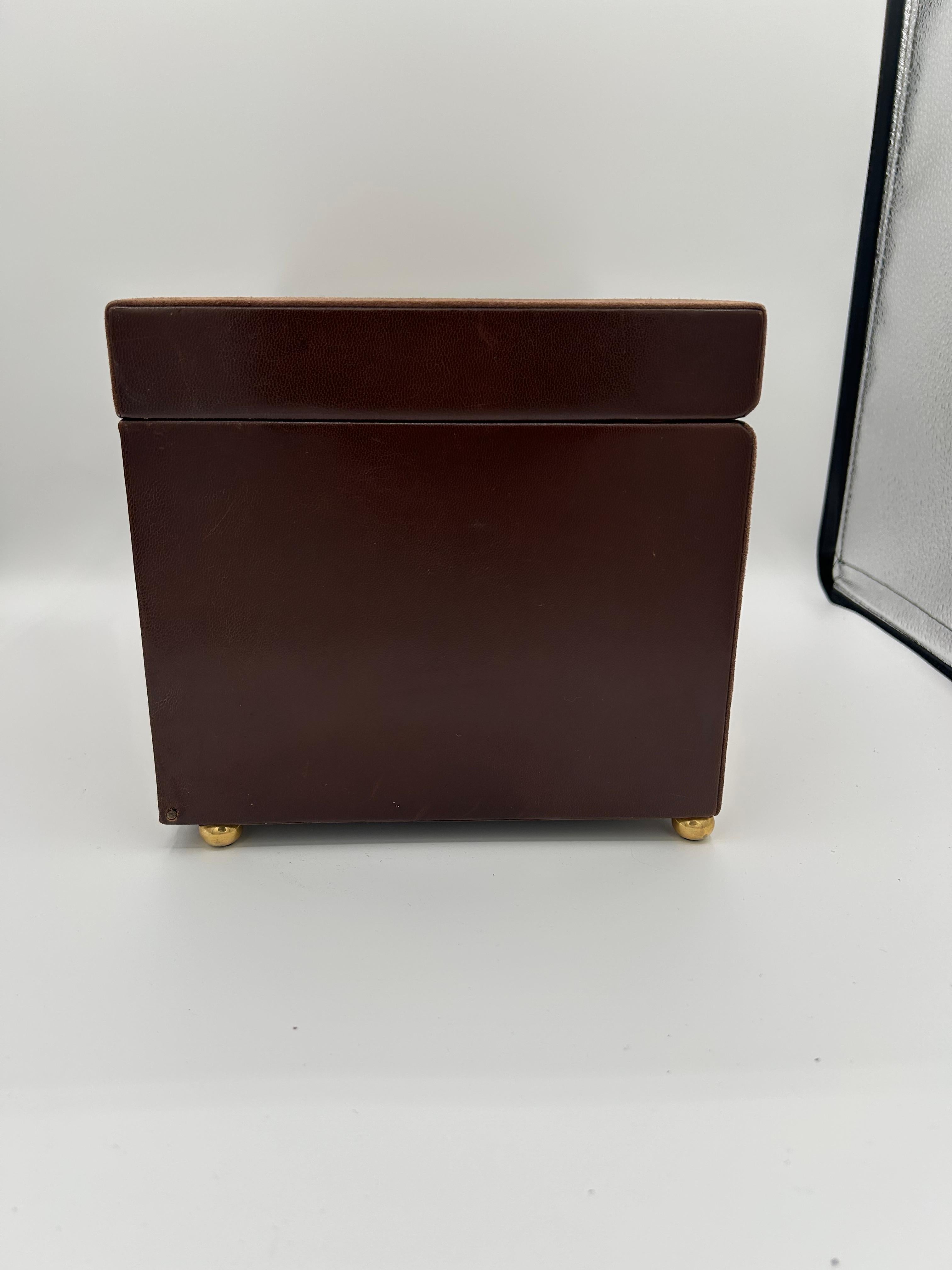 Made in Italy, a beautiful chocolate brown suede and leather hinged jewelry box with lock and key by designer Mark Cross. Box interior is a brown suede. Exterior is brown suede and leather. Hinged front door drops down to expose 2 interior drawers