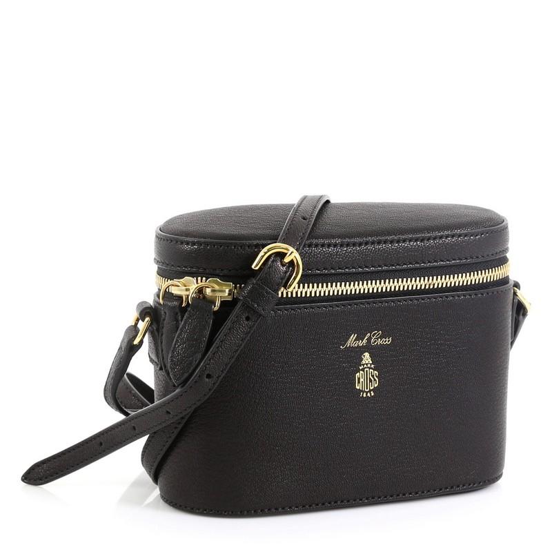 This Mark Cross Ginny Crossbody Bag Leather, crafted in black leather, features an adjustable leather strap, cylindrical design and gold-tone hardware. Its zip closure opens to a red leather interior with zip pocket. .

Estimated Retail Price: