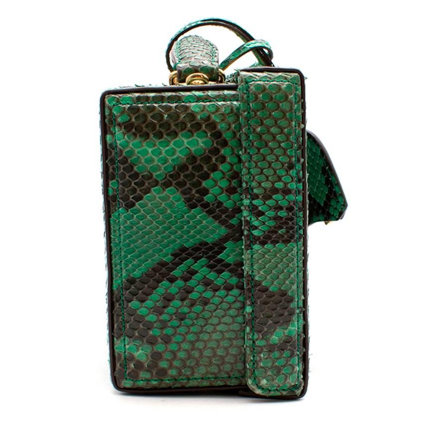Mark Cross Grace small green python box bag

Featuring:
-single top handle and detachable shoulder strap
-zipped interior pocket
-gold tone hardware
-contrasting red leather lining
-protective bottom studs
-push-lock with key
-written designer logo