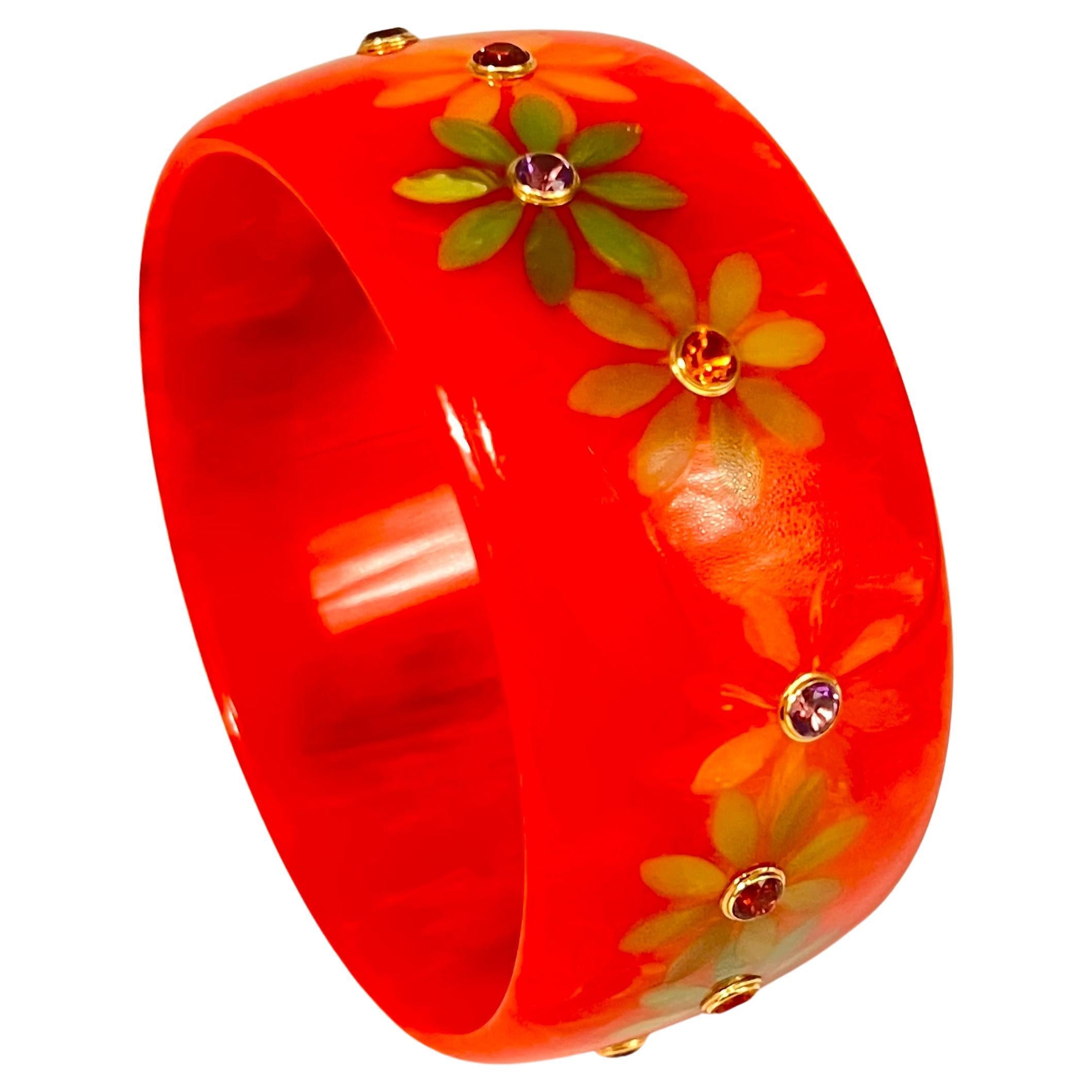 Wide pinkish-orange colored vintage bakelite bangle with inlaid floral-shaped vintage green-oange bakelite, accented by round faceted multi-colored natural gemstones including amethyst, citrine, garnets all bezel-set in 18k yellow gold mounts. 