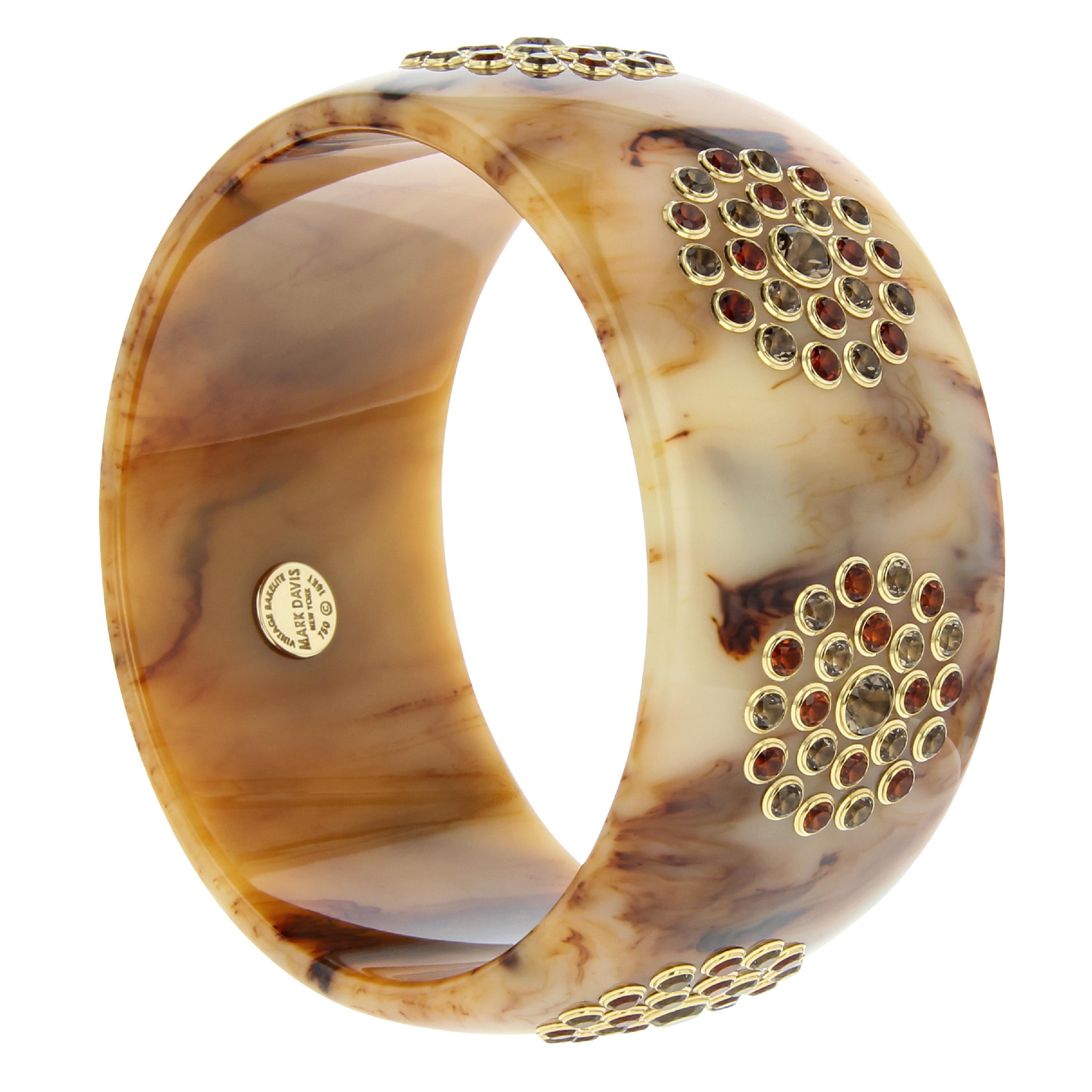 Another classic Mark Davis bangle. Beautiful, marbled brown bakelite with 7 stations of precisely set gemstones in individual 18k yellow gold bezels. Neutral but far from boring, this bangle is gorgeous on its own and even better stacked with