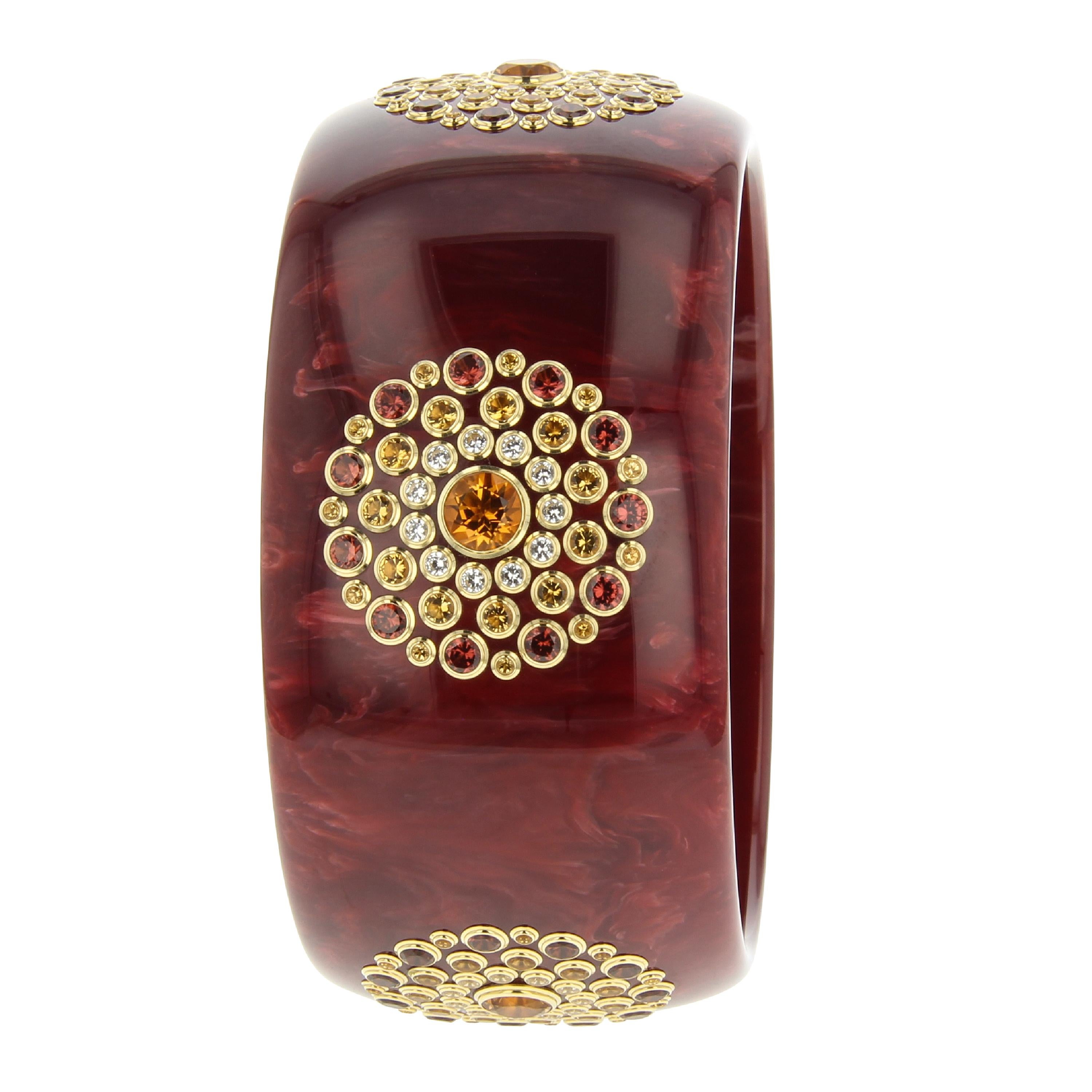 A classic Mark Davis bangle of vintage burgundy bakelite with five stations of perfectly placed fine gemstones set in individual 18k gold bezels. A very rich and elegant bangle that will pair well with browns, pinks, yellows and black.

Full details