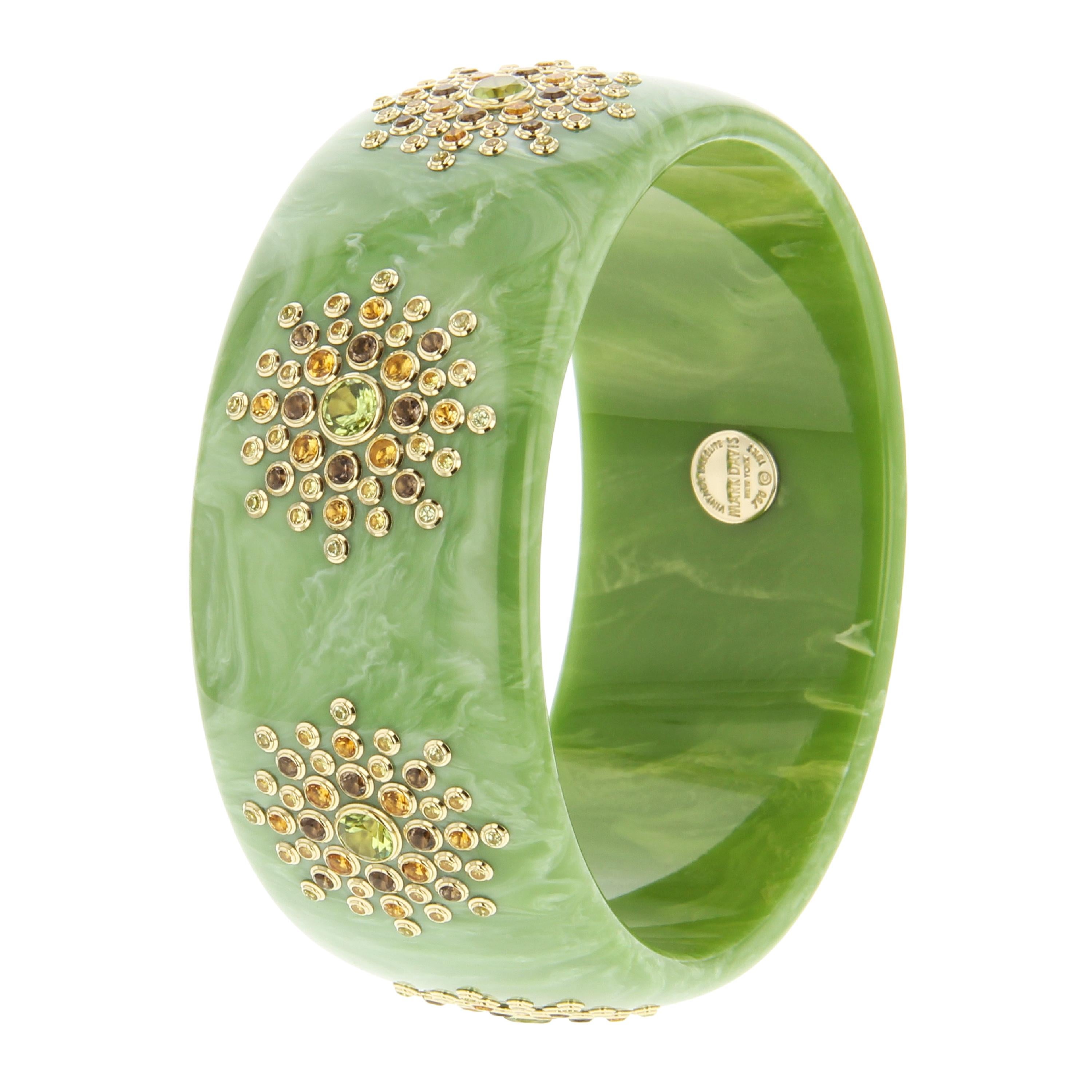 A lovely, soft, powdery green Mark Davis bangle of vintage bakelite. Set with seven stations of smoky quartz, citrine, peridot and yellow sapphire. A very pretty and feminine bangle that is charming without being saccharine sweet.

Full details