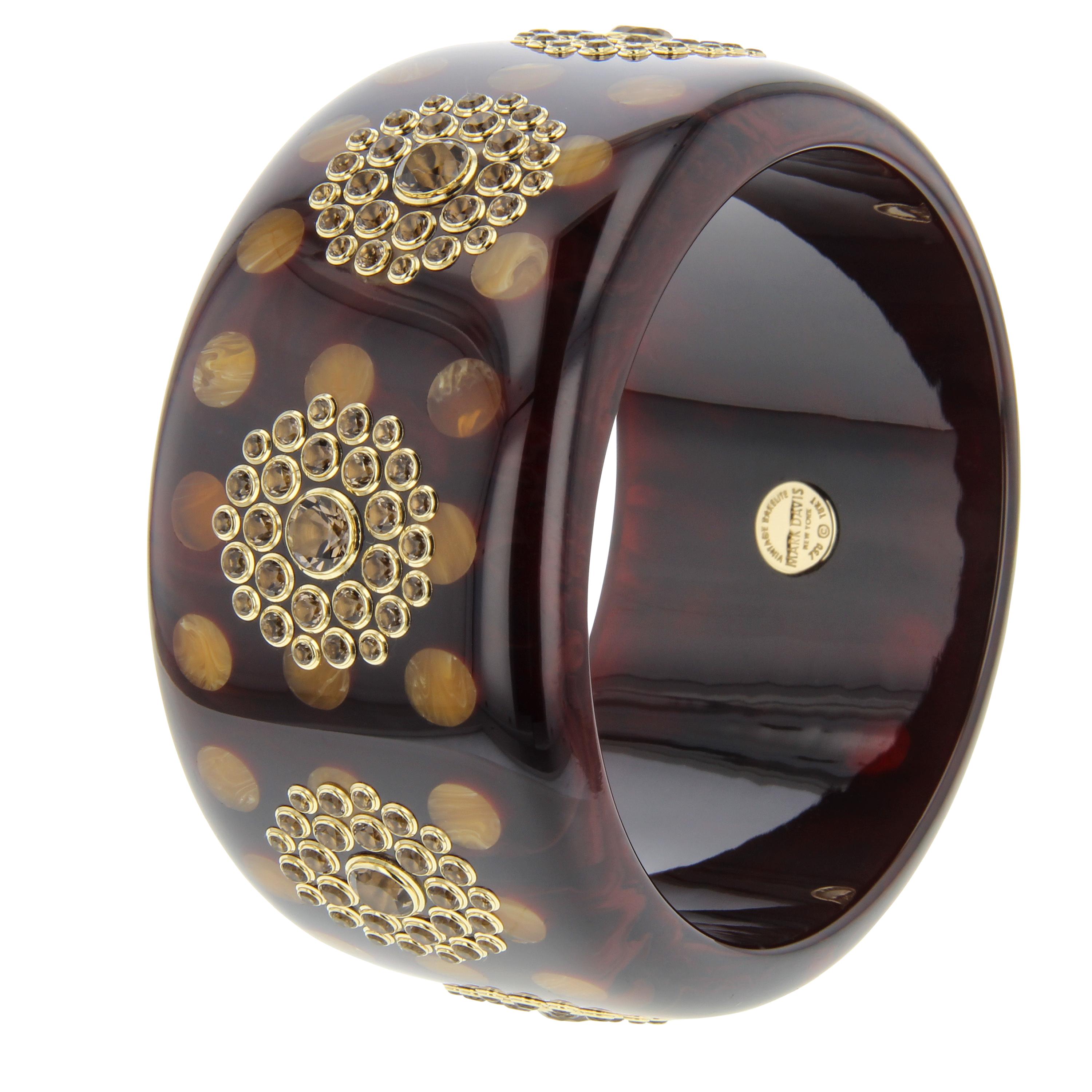 This very special Mark Davis bangle was created with a deep, rich, brown, vintage bakelite inlaid with orange bakelite polka dots. The piece was then set with smoky quartz of varying sizes arranged in tight clusters around the circumference of the