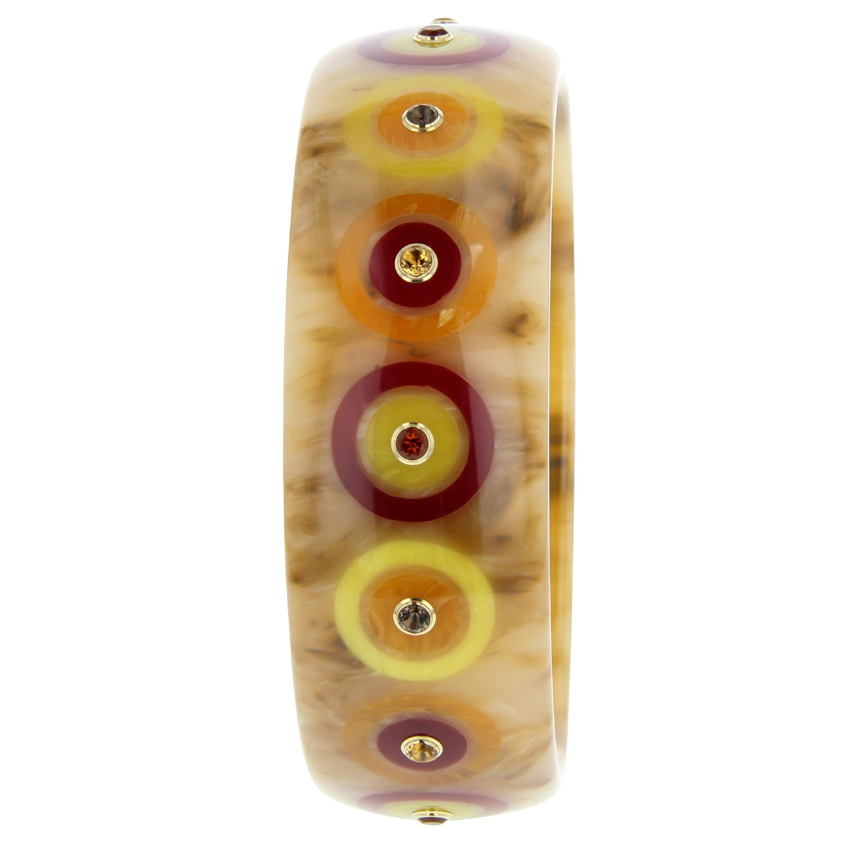 This bullseye patterned Mark Davis bangle was handcrafted using a classic, marbled, brown, vintage bakelite set with bullseyes created with burgundy, yellow and orange bakelite inlay. Each bullseye is centered with a light or dark citrine or smoky