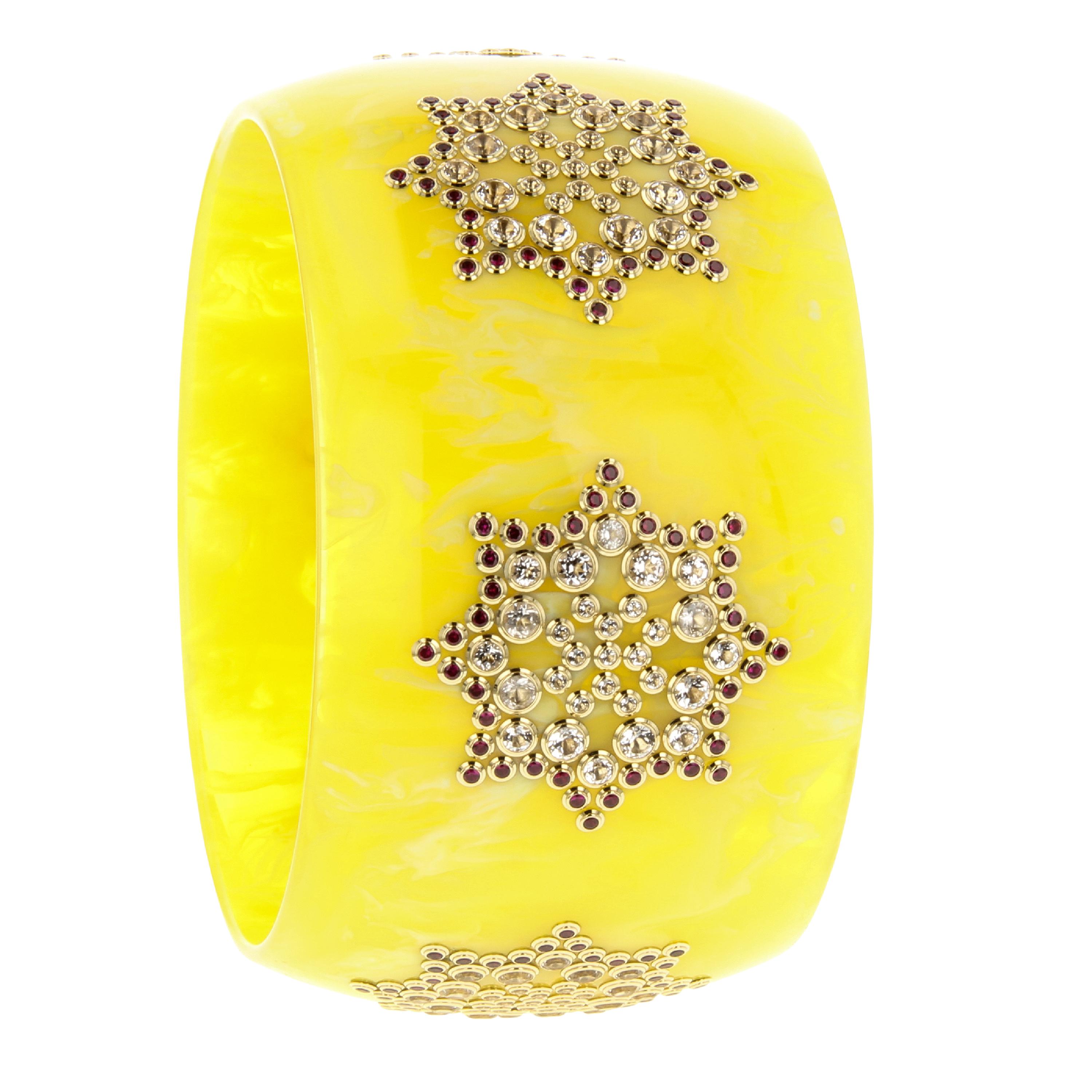 This spectacular Mark Davis bangle of brilliant, yellow, vintage bakelite has been set with a complex geometric motif of fine, perfectly matched rubies and sparkling white topaz. One-of-a-kind and very special.

Full details below:
• From the Mark