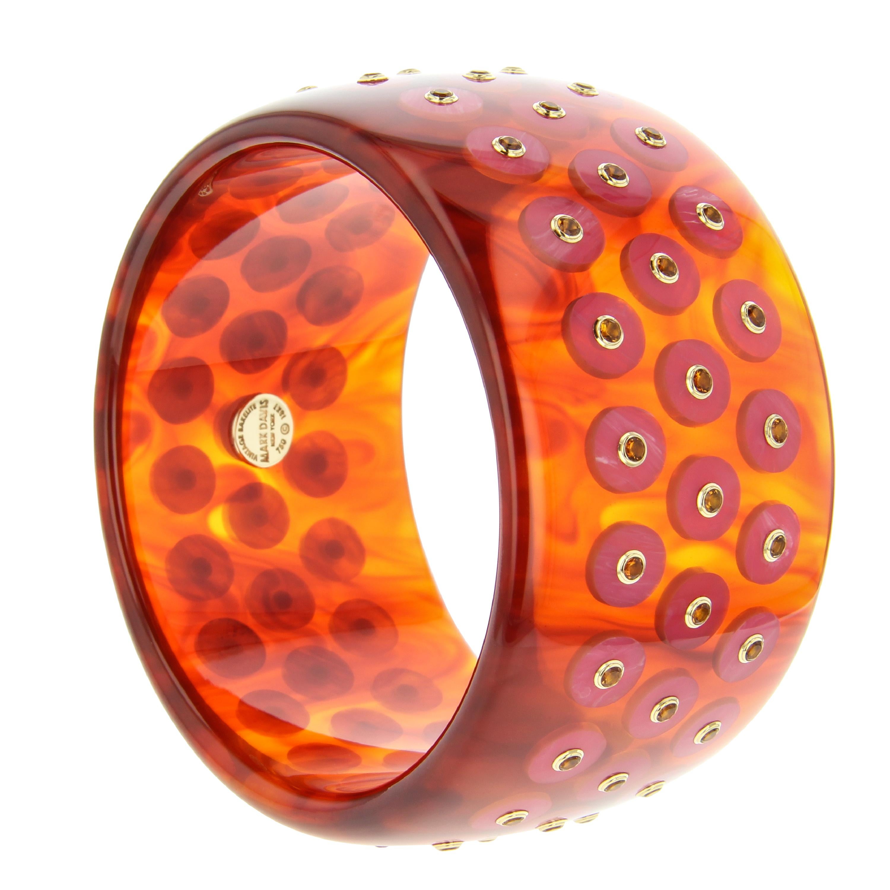 This chic Mark Davis bangle was handcrafted using a warm, reddish, tortoiseshell color vintage bakelite inlaid with pink bakelite polka dots centered with citrine set in individual 18k yellow gold bezels.

Full details below:
• From the Mark Davis