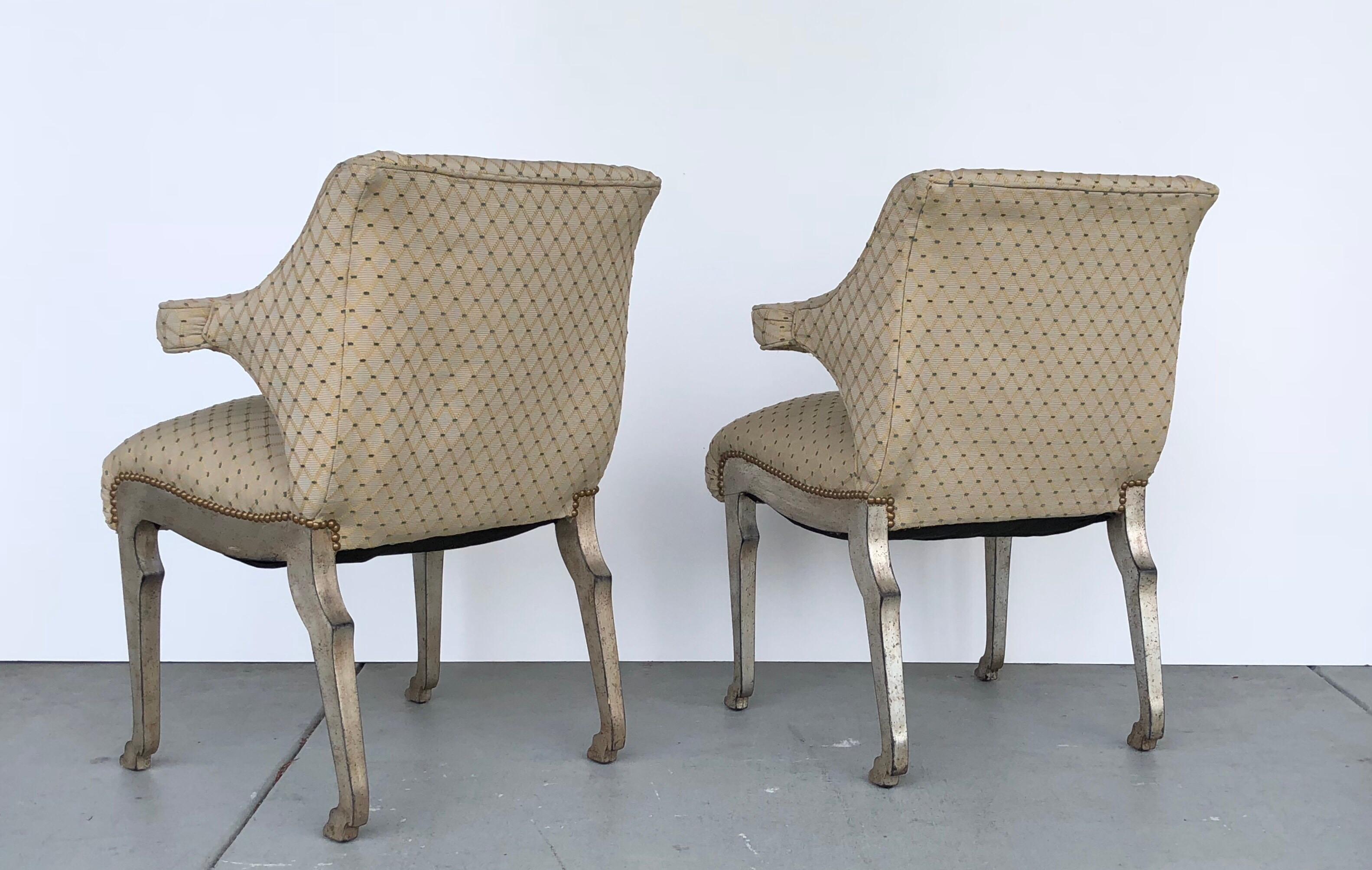 A pair of midcentury chairs with wonderful animal legs. The wood legs are finished in silver gilt. The seats are upholstered. Great design that is stunning from every angle.