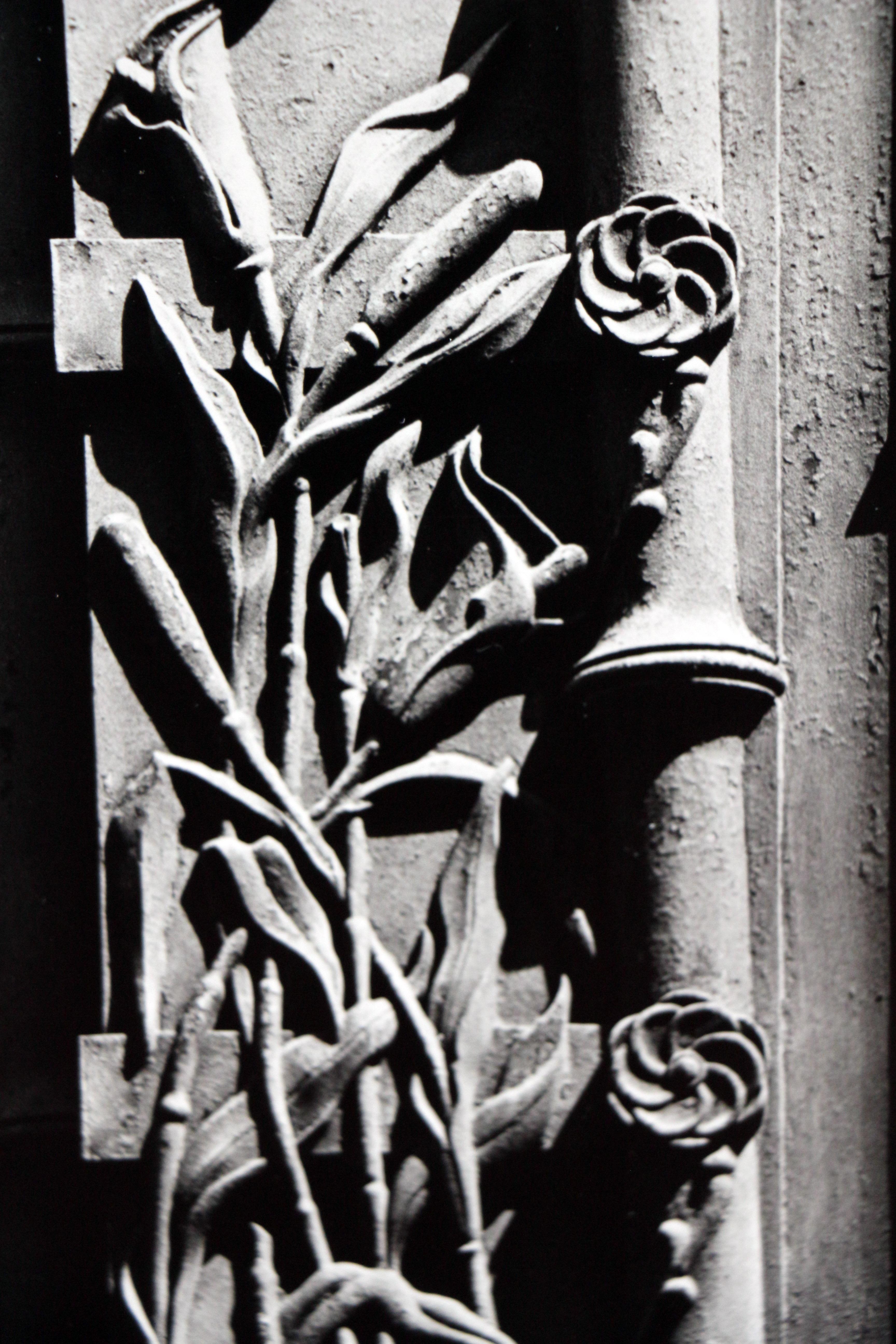 This vintage black and white silver gelatin print depicts the exterior details of a building in New York City with the intricate architectural designs of columns and flowers.

Mark Feldstein (1937—2001) was an American photographer best known for