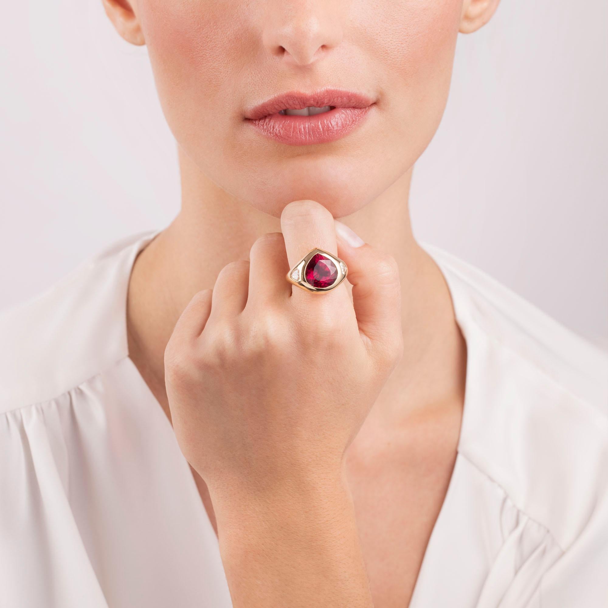 A simple yet striking modern heirloom, our Chunky Ring showcases a fiery rubellite tourmaline that is burnish set into a sleek 18k gold mounting which is polished to perfection. Two brilliant fancy cut shield diamonds are set along the outer edges