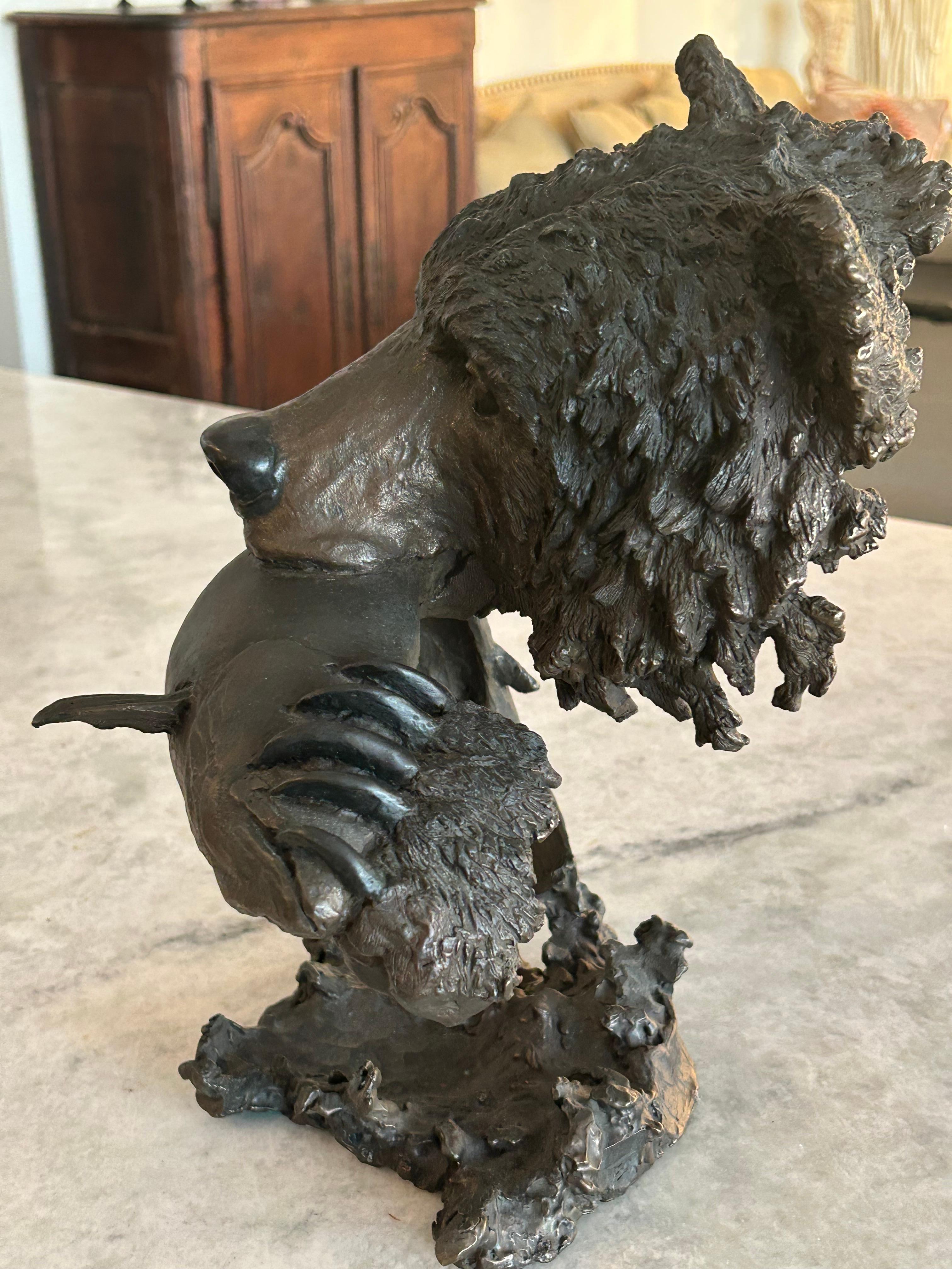 Mark Hopkins, bronze titled “Fishing Grizzly”.grizzly bear with rainbow trout 2