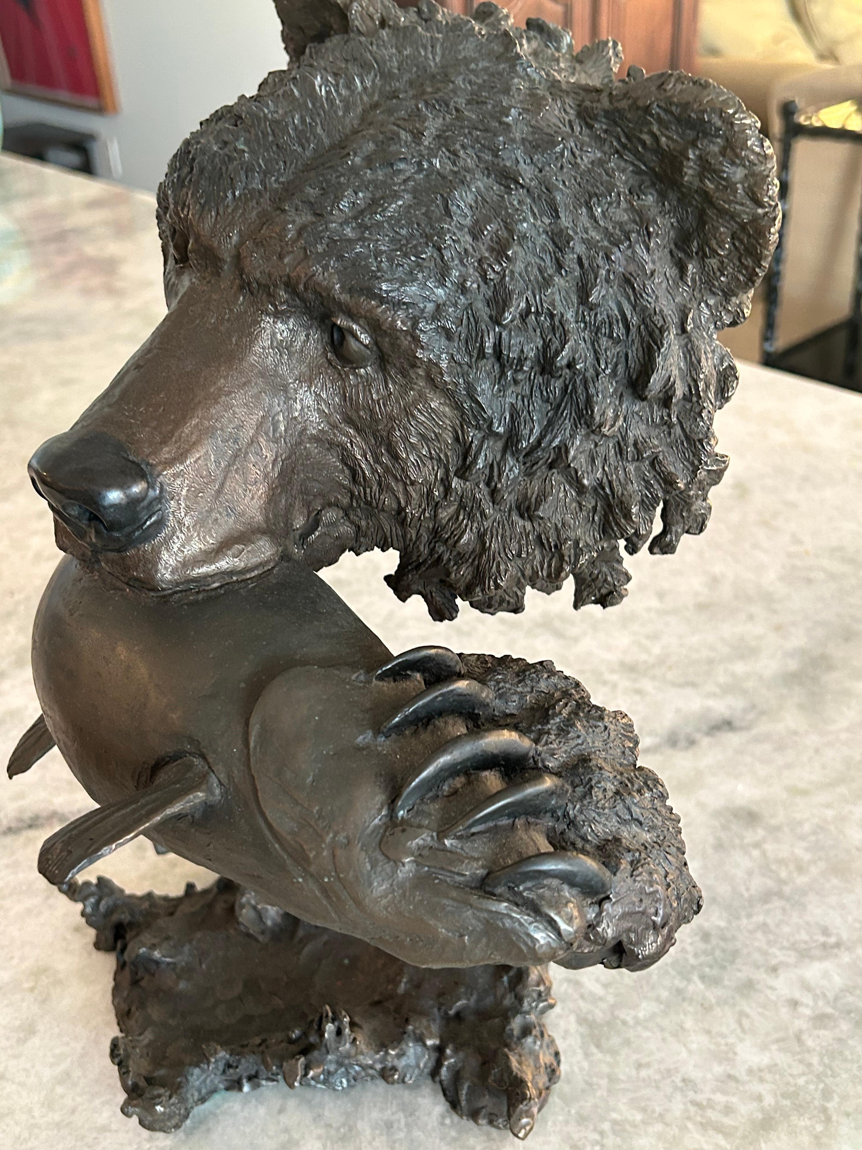 Cast Mark Hopkins, bronze titled “Fishing Grizzly”.grizzly bear with rainbow trout