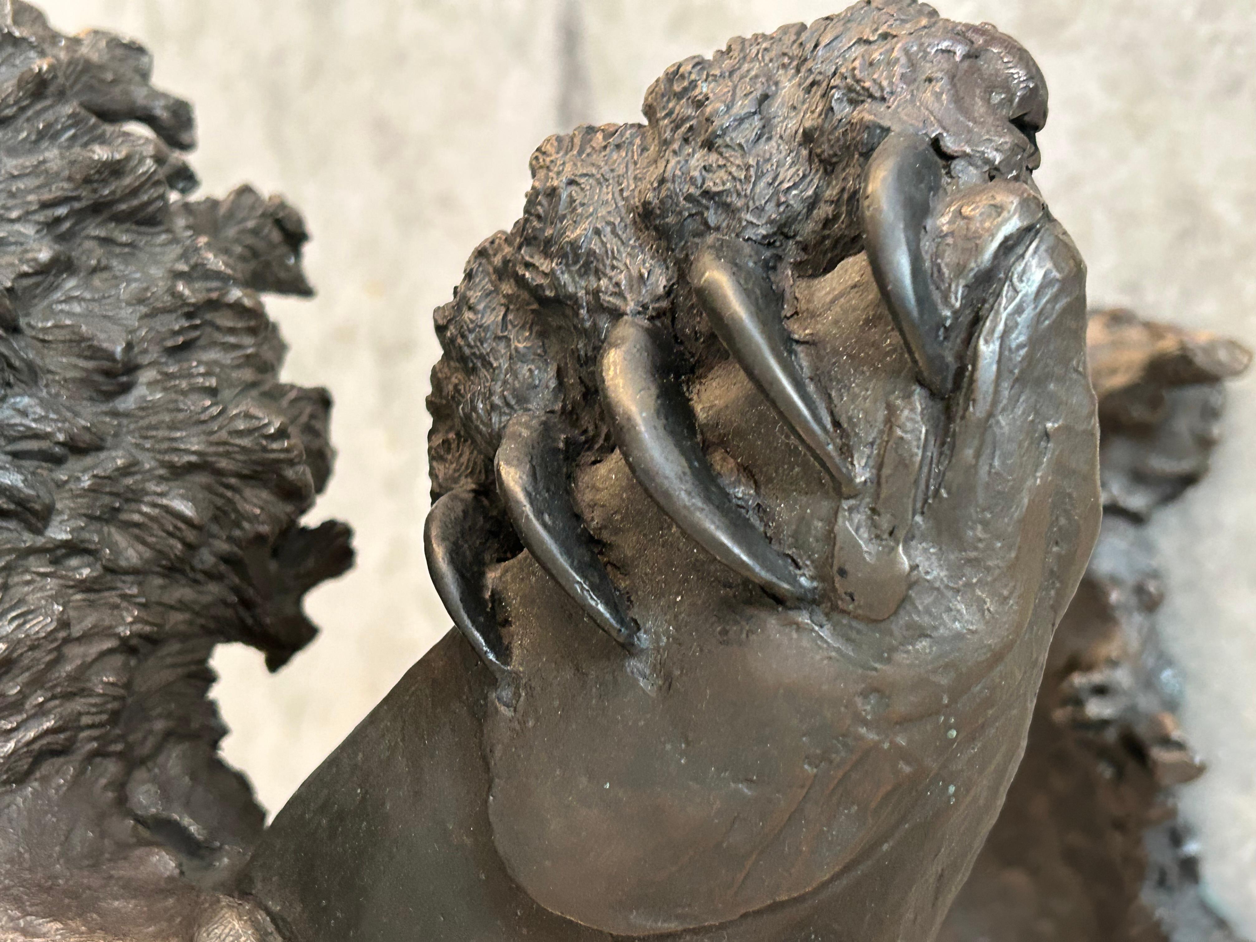 Mark Hopkins, bronze titled “Fishing Grizzly”.grizzly bear with rainbow trout 1