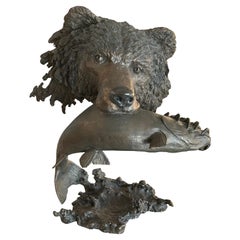 Mark Hopkins, bronze titled “Fishing Grizzly”.grizzly bear with rainbow trout