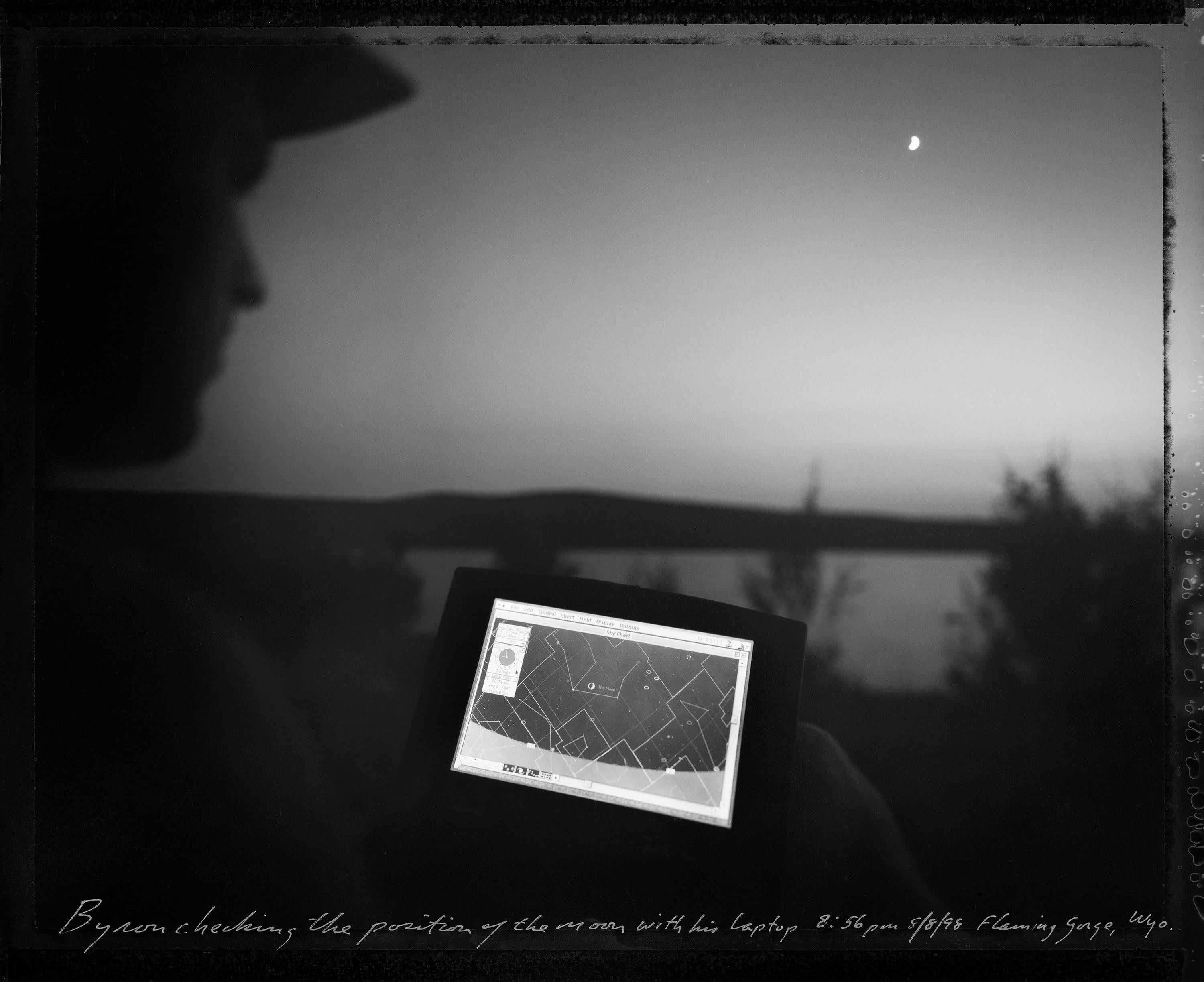 Mark Klett Black and White Photograph -  Byron Checking the Position of the Moon with his Laptop, Flaming Gorge, WY