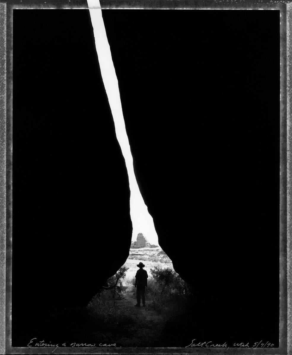 Mark Klett Black and White Photograph - Entering a Narrow Cave, Salt Creek, Utah, 5/9/90