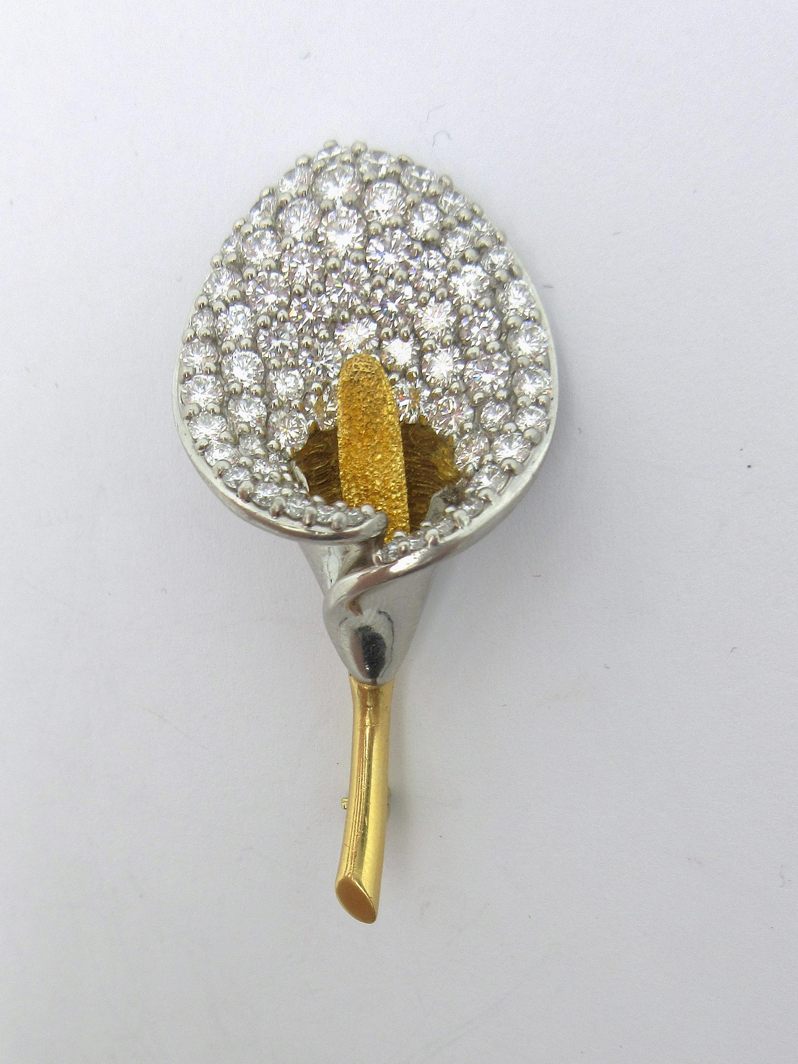This exquisite brooch by designer Mark Patterson was made to depict a calla lily.  The flower is made in expert detail, with an 18k yellow gold stem and stadix, and platinum spathe.  The spathe is pave-set with approximately 4.75cttw of round