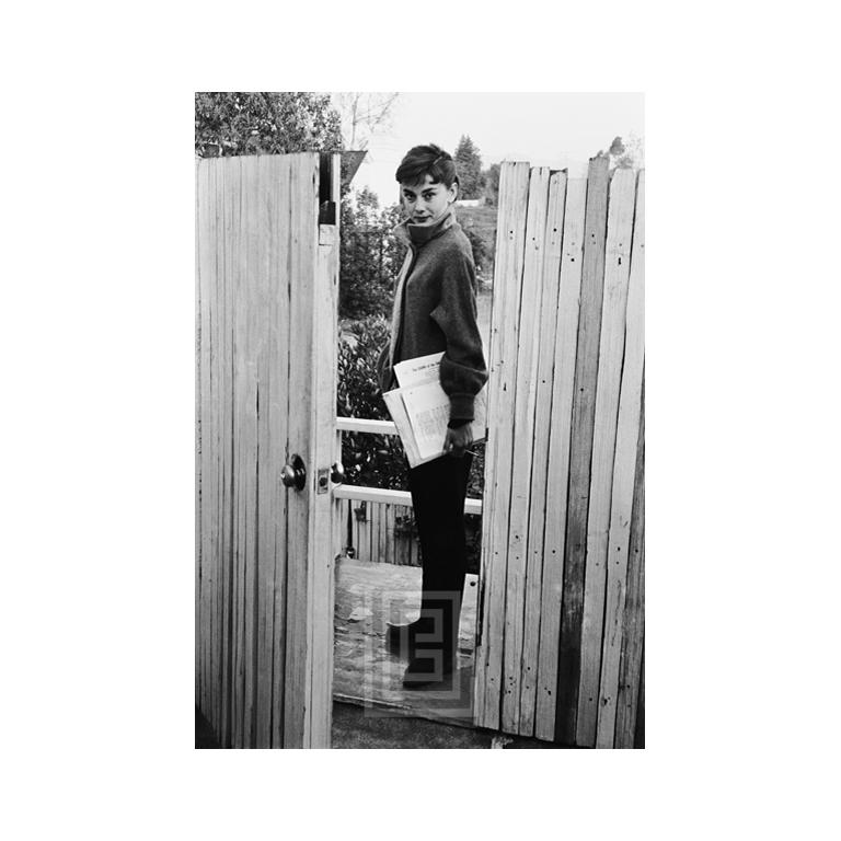 Black and White Photograph Mark Shaw - Audrey Hepburn at Apartment Gate (Audrey Hepburn à Apartment Gate), 1953